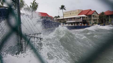 Waves crash against a seawall as Hurricane Ian passes through George Town, Grand Cayman island, Monday, Sept. 26, 2022. (AP Photo/Kevin Morales)