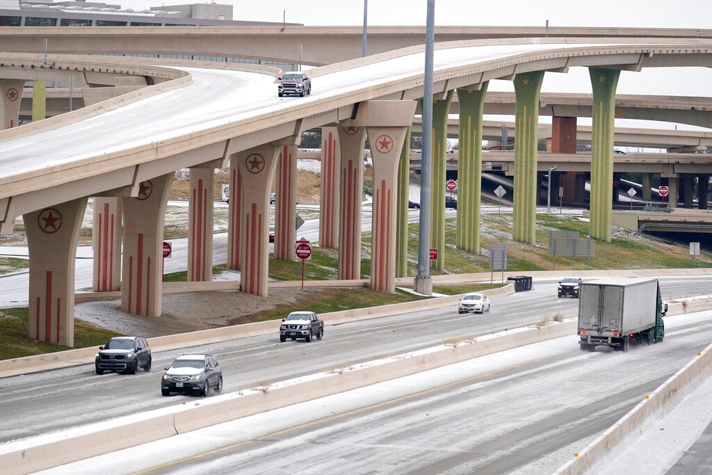 Drivers slowly navigate through icy road conditions at the US 75 highway and LBJ 635 interchnage Tuesday, Jan. 31, 2023, in Dallas. (AP Photo/Tony Gutierrez)