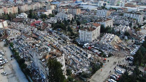 Aerial photo shows the destruction in Hatay city center, southern Turkey, Tuesday, Feb. 7, 2023. Search teams and emergency aid from around the world poured into Turkey and Syria on Tuesday as rescuers working in freezing temperatures dug — sometimes with their bare hands — through the remains of buildings flattened by a magnitude 7.8 earthquake. (IHA via AP)