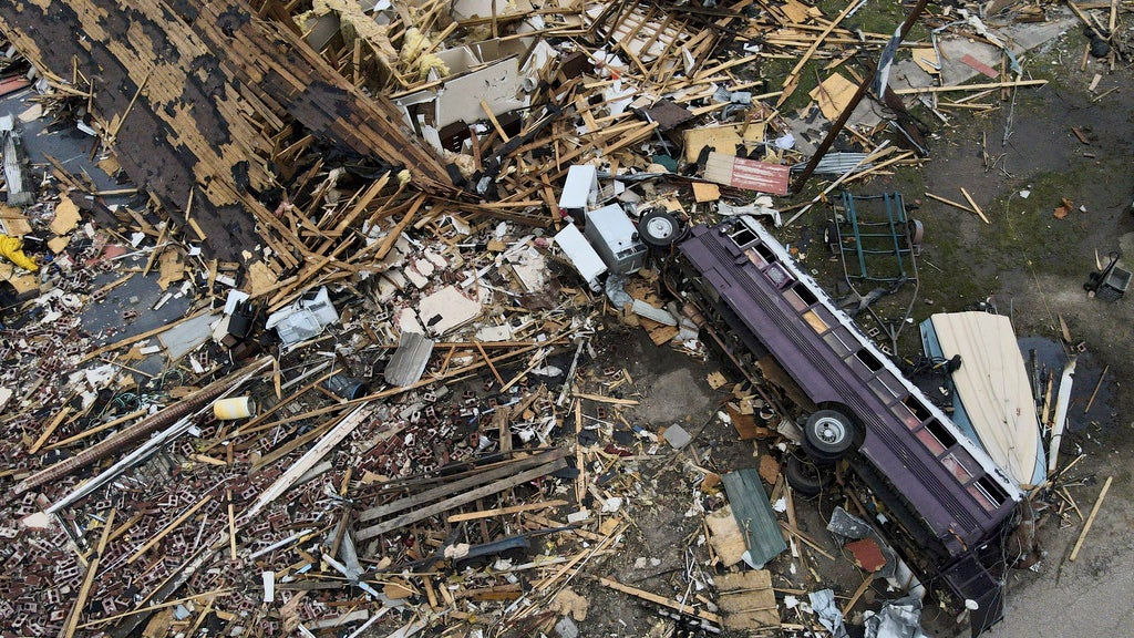 Debris is strewn about tornado damaged homes, Sunday, March 26, 2023, in Rolling Fork, Mississippi. At least 25 people were killed and dozens of others were injured in Mississippi as the massive storm ripped through several towns. (AP Photo/Julio Cortez)