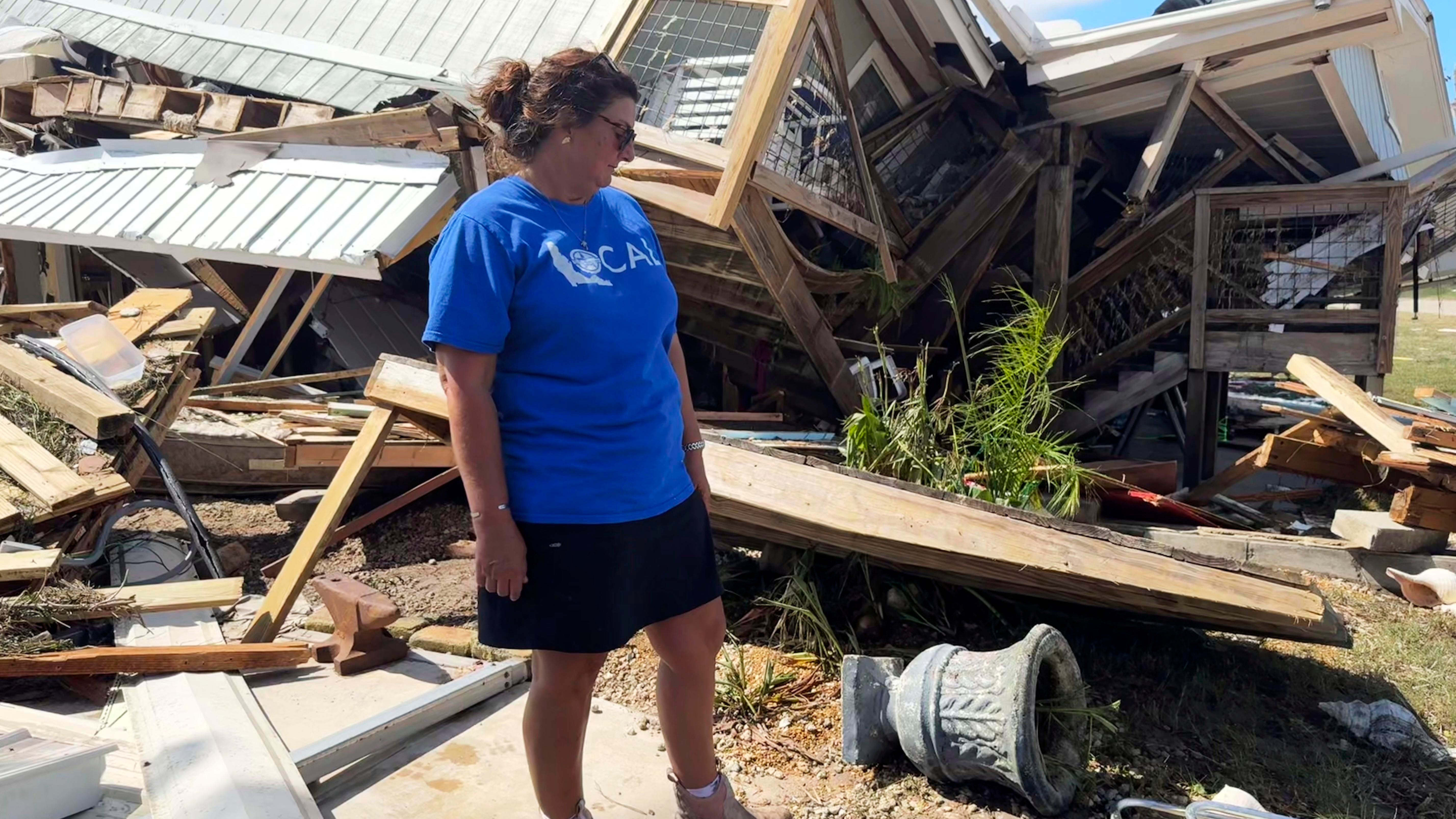 Laurie Lilliott stands amid the wreckage of her destroyed home in Dekle Beach in rural Taylor County, Fla., Friday, Sept. 27, 2024, in the aftermath of Hurricane Helene. (AP Photo/Kate Payne)