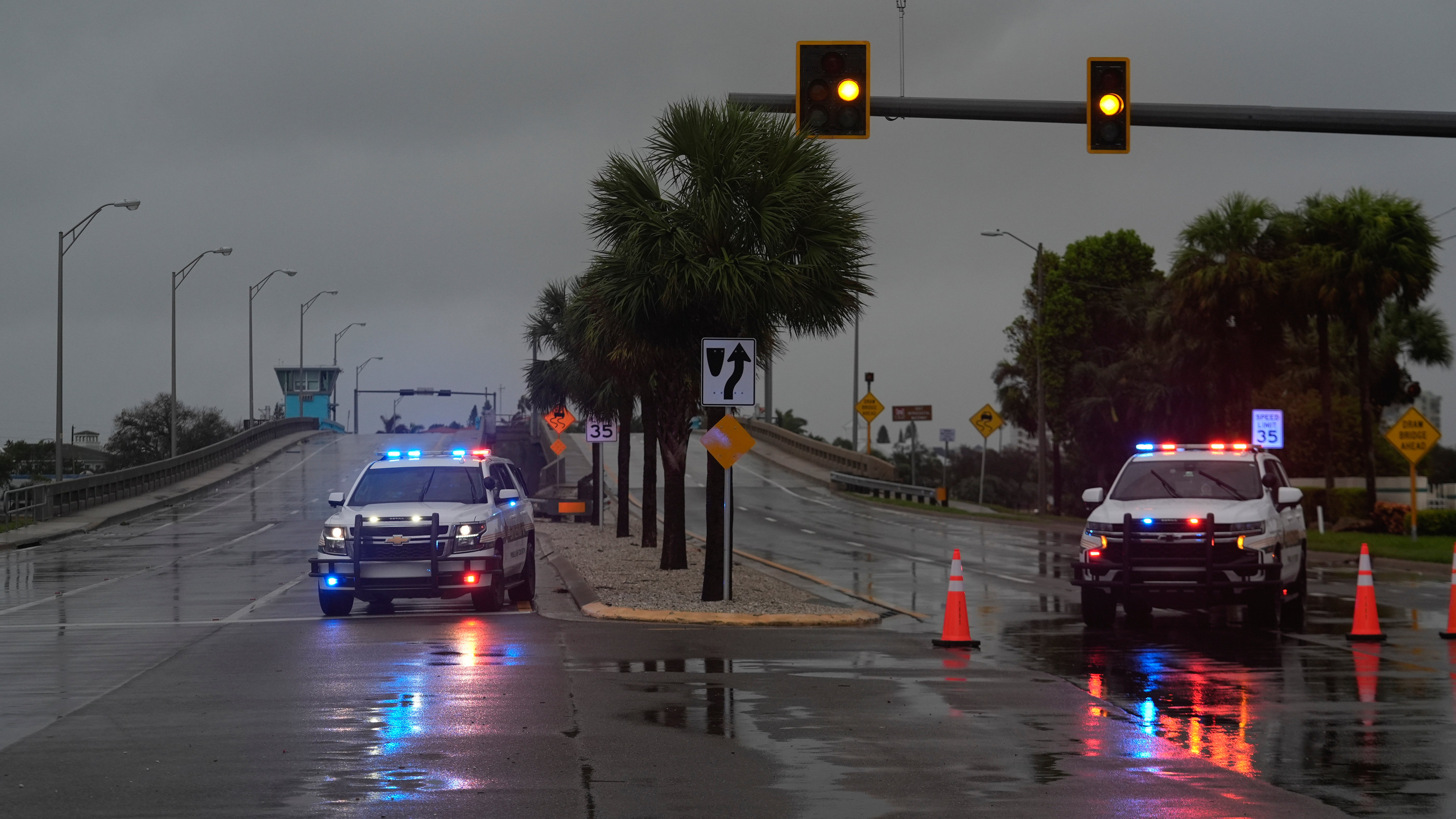 Police block off a bridge leading to the barrier island of St. Pete Beach, Fla., ahead of the arrival of Hurricane Milton, in South Pasadena, Fla., Wednesday, Oct. 9, 2024. (AP Photo/Rebecca Blackwell)