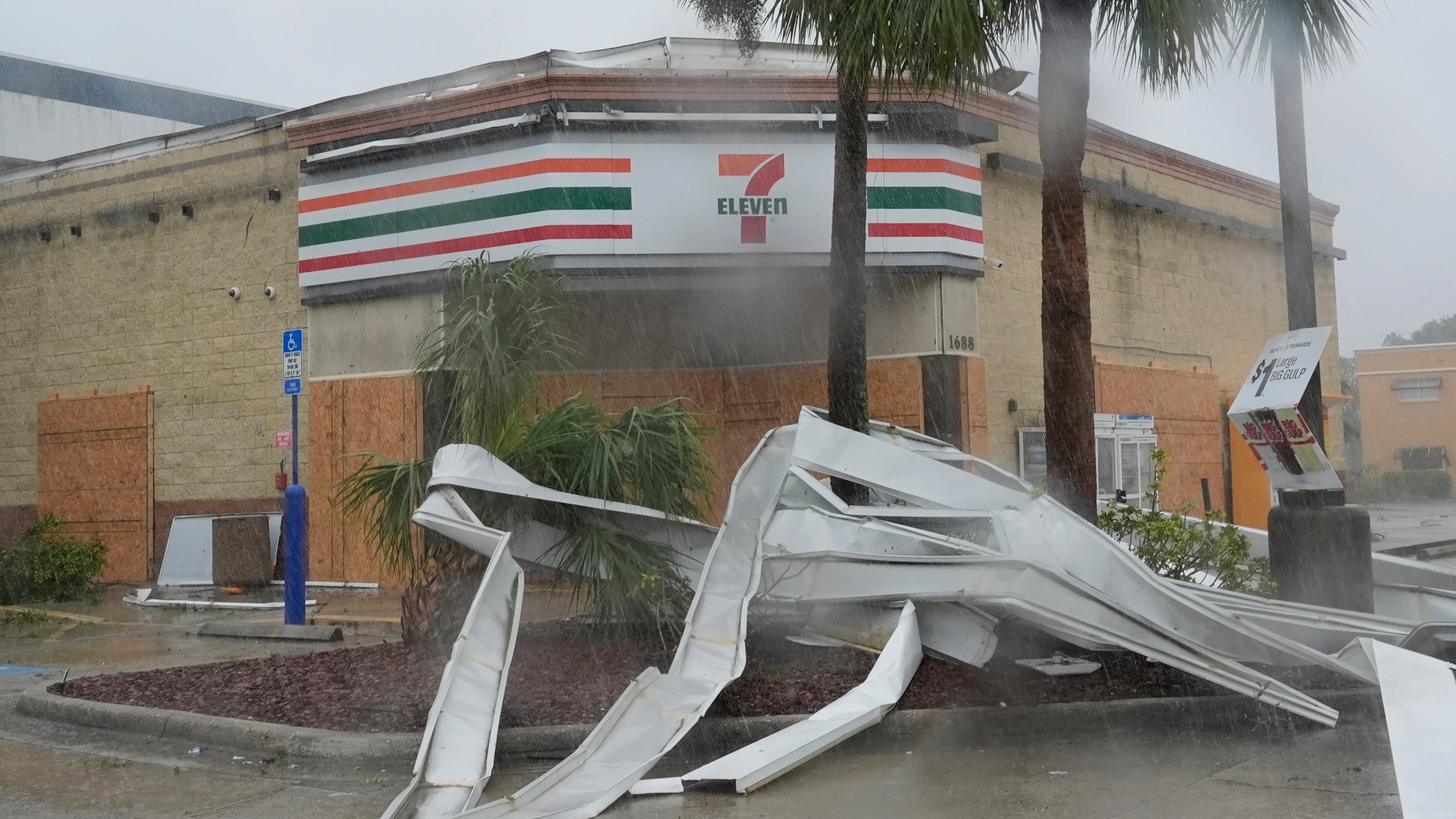 An apparent tornado caused by Hurricane Milton, tore the awning off a 7-Eleven convenience store, Wednesday, Oct. 9, 2024, in Cape Coral, Fla.(AP Photo/Marta Lavandier)