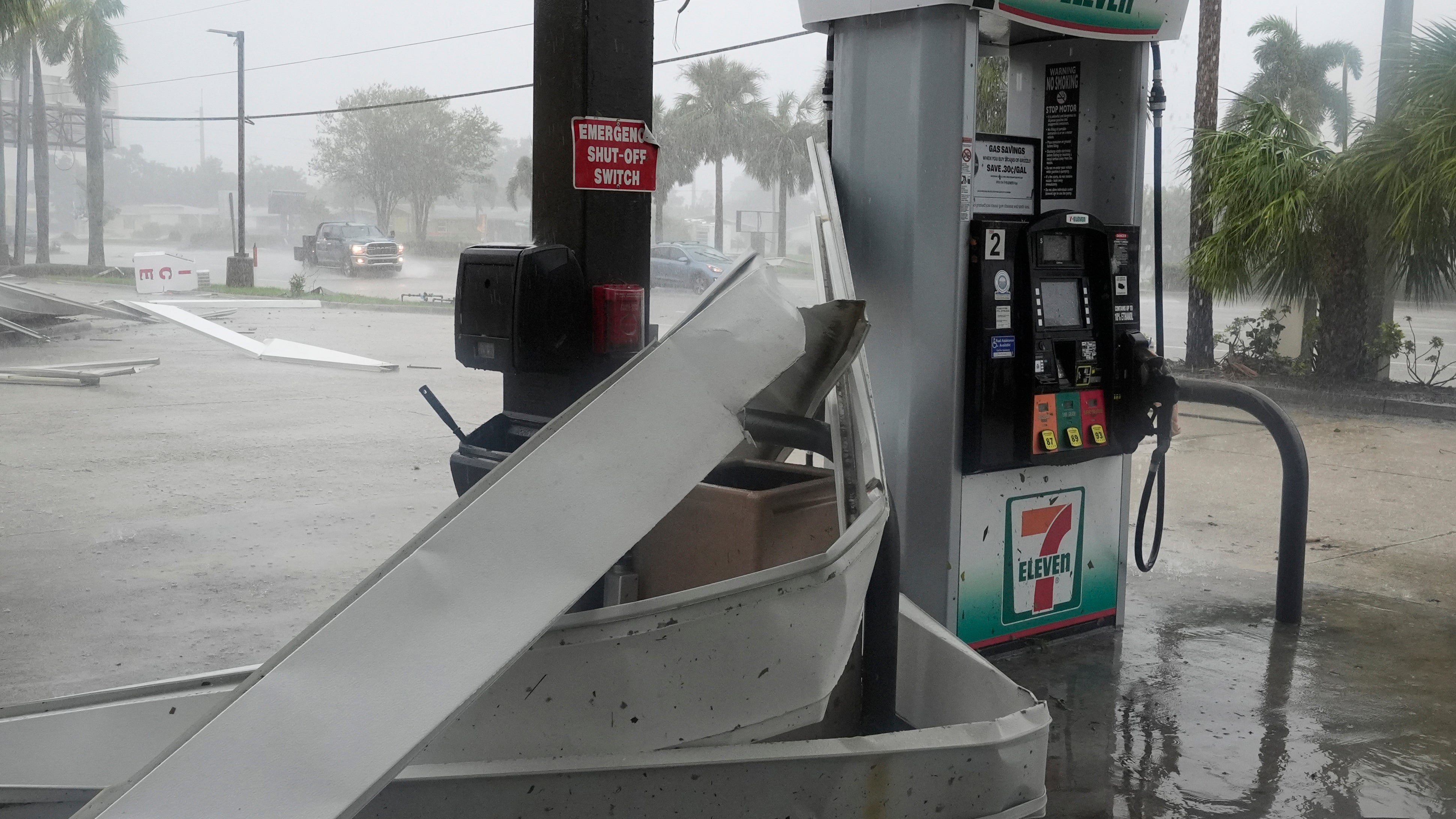 An apparent tornado caused by Hurricane Milton, tore the awning off a 7-Eleven convenience store, Wednesday, Oct. 9, 2024, in Cape Coral, Fla.(AP Photo/Marta Lavandier)