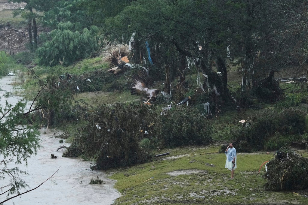 A man surveys damage left by a raging Guadalupe River, Friday, July 4, 2025, in Kerrville, Texas. (AP Photo/Eric Gay)