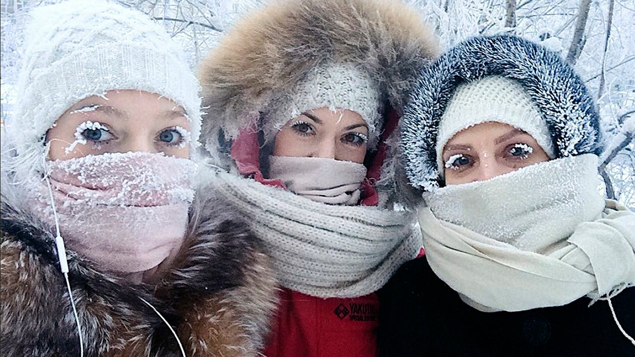 In this photo taken on Sunday, Jan. 14, 2018, Anastasia Gruzdeva, left, poses for selfie with her friends as the temperature dropped to about -58 degrees Fahrenheit in Yakutsk, Russia. Temperatures in the remote, diamond-rich Russian region of Yakutia have dropped to near-record lows, plunging to -88.6 degrees Fahrenheit in some areas. (sakhalife.ru photo via AP)                                       