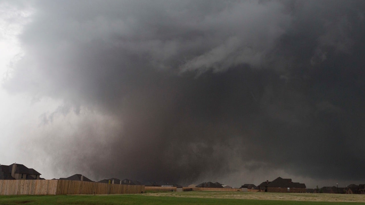 FILE - In this Monday, May 20, 2013 file photo, a tornado moves past homes in Moore, Okla. Emergency officials in Oklahoma, Texas and Kansas are bracing for the start of what's historically the most active time of year for tornadoes while also facing wildfire threats because of severe drought conditions. (AP Photo/Alonzo Adams. File)