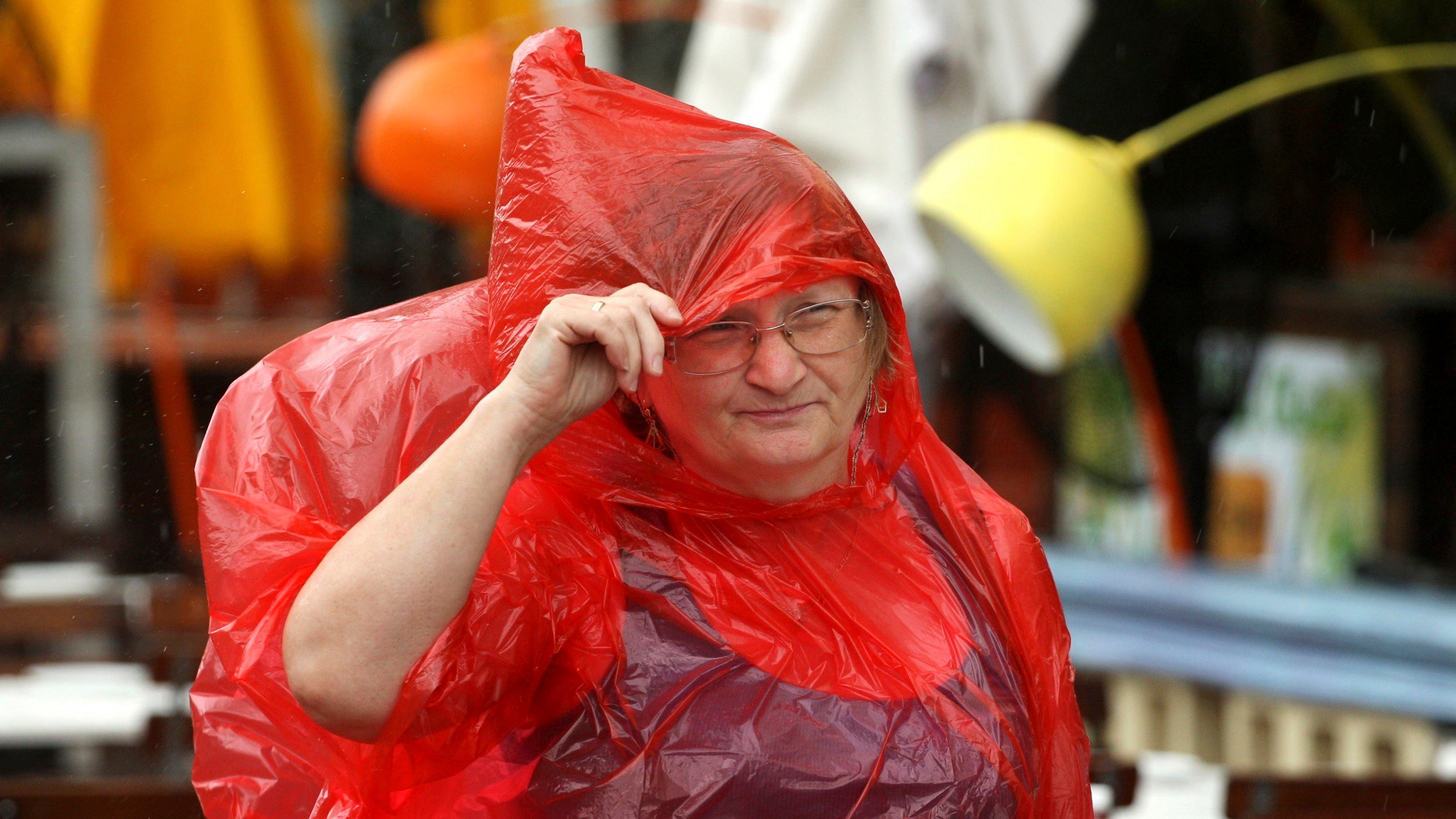 A South Beach tourist from Hungary braves the bad weather as she strolls down the empty sidewalks of Ocean Drive as a tropical storm warning was issued for coastal Miami-Dade, Fla., Monday, Sept. 3, 2018.  Tropical Storm Gordon lashed South Florida with heavy rains and high winds on Monday, forcing holiday beachgoers to drier ground.  (Carl Juste/Miami Herald via AP)