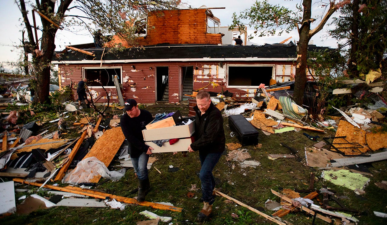 People collect personal belonging from damaged homes after a tornado in Dunrobin, Ontario, west of Ottawa on Friday, September 21, 2018. (Sean Kilpatrick/The Canadian Press via AP)