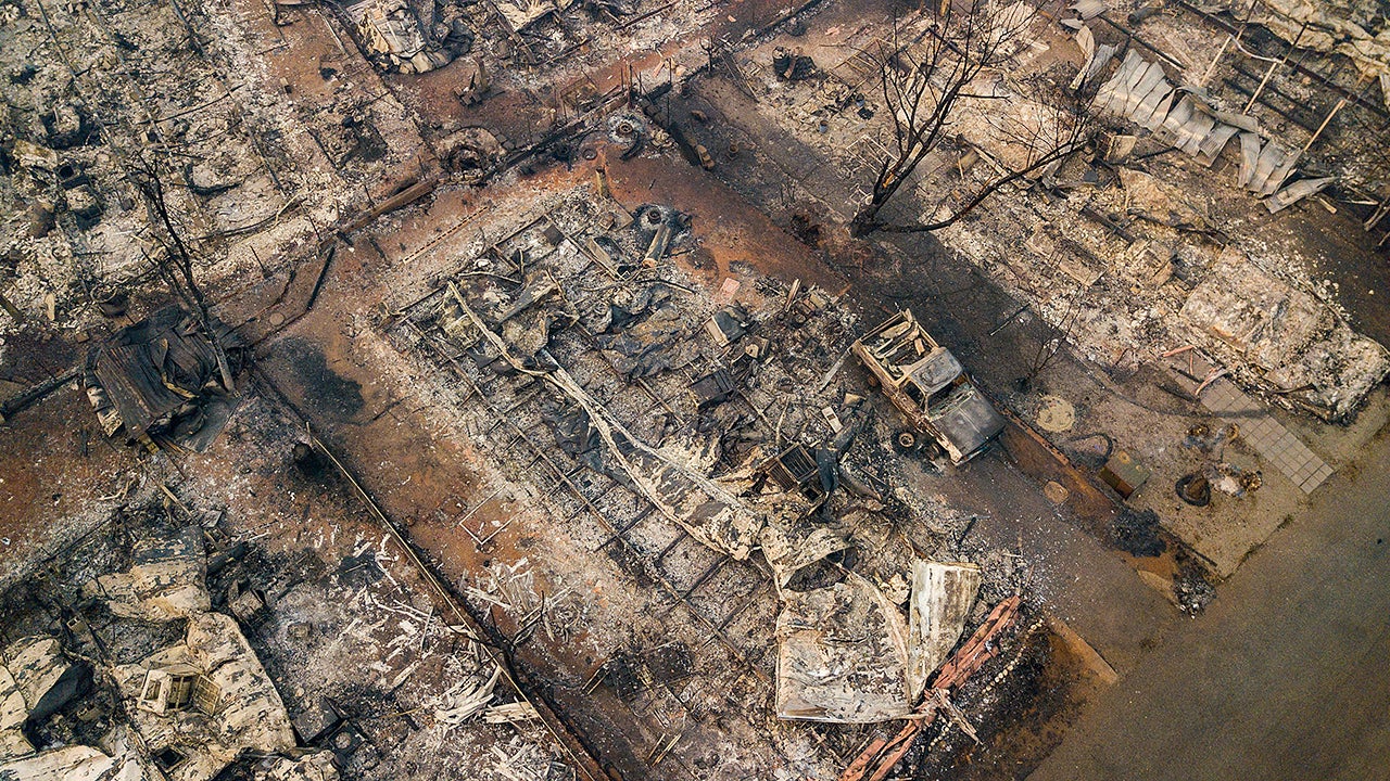 Debris and residences leveled by the wildfire line a neighborhood in Paradise, Calif., on Thursday, Nov. 15, 2018. The California Department of Forestry and Fire Protection said Thursday the wildfire that destroyed the town of Paradise is now 40 percent contained, up from 30 percent Wednesday morning.  (AP Photo/Noah Berger)