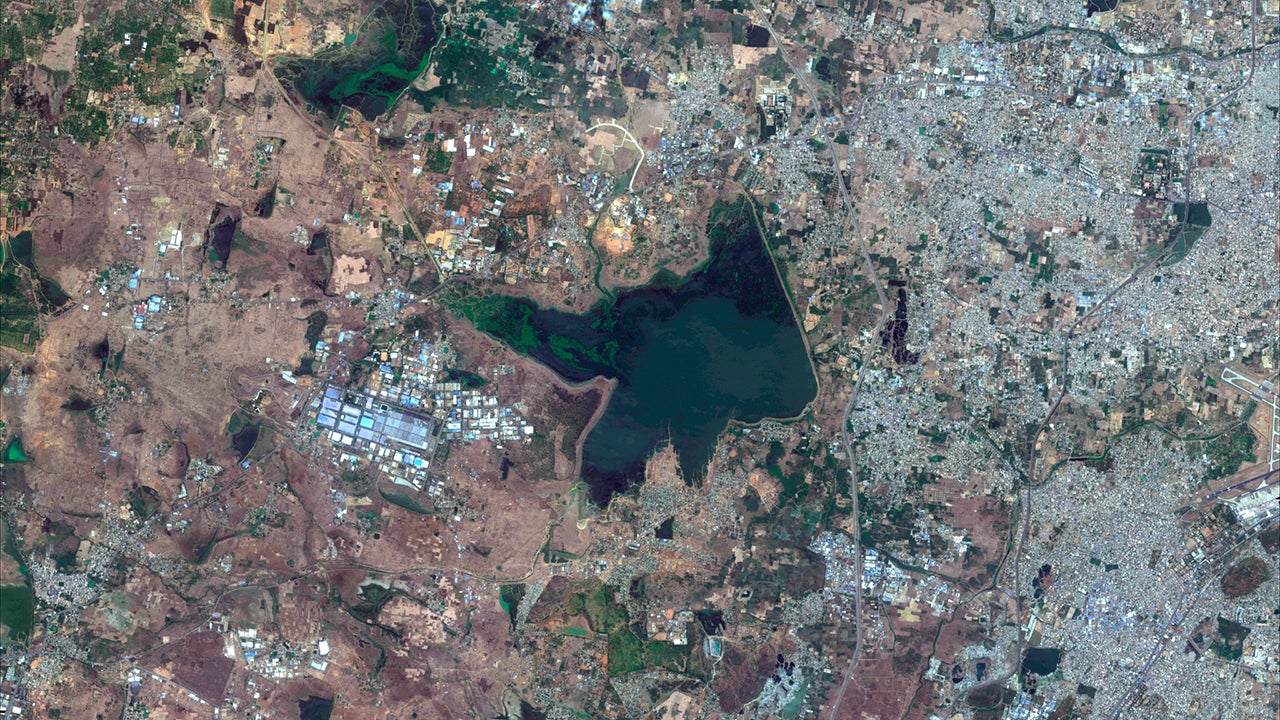 This June 15, 2018, Copernicus Sentinel-2 Satellite image provided by Maxar Technologies shows Chembarambakkam Lake in Chennai, India before the drought. Millions of people are turning to water tank trucks in the southern Indian state of Tamil Nadu as house and hotel taps run dry because of an acute water shortage caused by drying lakes and depleted groundwater. (Copernicus Sentinel-2 Satellite Image/Maxar Technologies via AP)