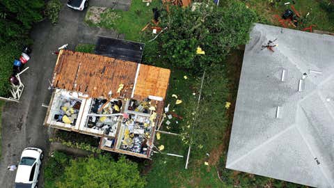 An aerial view shows a building housing that had its roof blown off during a tornado spawned by Tropical Storm Cristobal. The EF1 tornado passed through Orlando, Florida, leaving at least 8 homes damaged, along with numerous reports of downed trees and power lines. No injuries have been reported. (Paul Hennessy / SOPA Images/Sipa USA via AP Images)