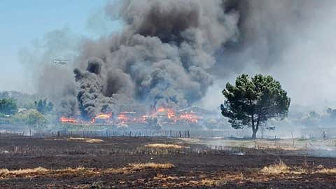 In this photo provided by the California Department of Forestry and Fire Prevention, the Nelson Fire burns Wednesday, June 17, 2020, near Oroville, Calif. Some residents of a Northern California county devastated by wildfire in 2018 are under evacuation orders because of a grass fire that has so far destroyed four homes. An evacuation order for parts of Oroville was issued after noon and the cause of the fire is under investigation. A 2018 wildfire in Butte County killed 85 people and destroyed more than 18,000 homes and buildings. (California Department of Forestry and Fire Prevention via AP)