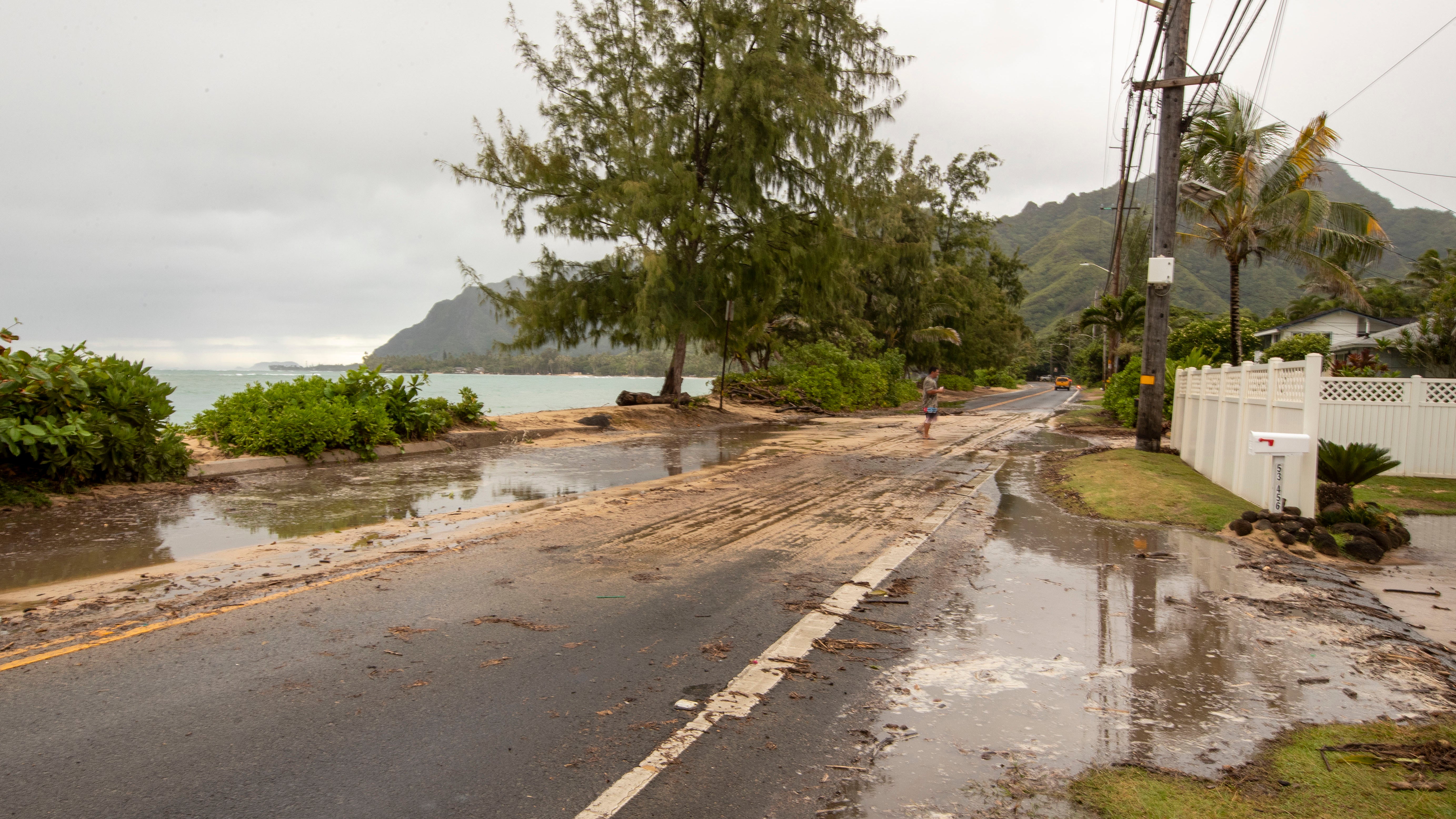 Sand and debris is left on Kamehameha Highway from high surf generated by Hurricane Douglas, Sunday, July 26, 2020, in Hauula, Hawaii. Hurricane Douglas came within &ldquo;razor thin&rdquo; distance of the Hawaiian Islands but spared the state the worst of the strong winds, storm surge and flooding officials had warned about. (AP Photo/Eugene Tanner)