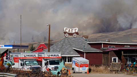 Smoke rises from mountain ridges as a wildfire burns south of Highway 34 Thursday, Oct. 22, 2020, near Granby, Colo. (AP Photo/David Zalubowski)