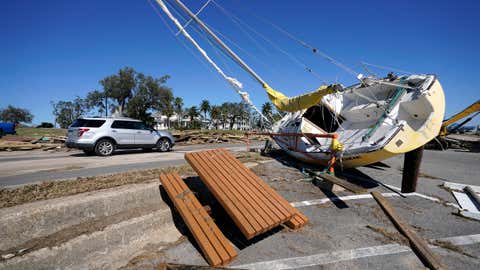 A sailboat sits among debris along Highway 90 in Pass Christian, Miss., Thursday, Oct. 29, 2020, in the aftermath of Hurricane Zeta, which passed through Wednesday. (AP Photo/Gerald Herbert)