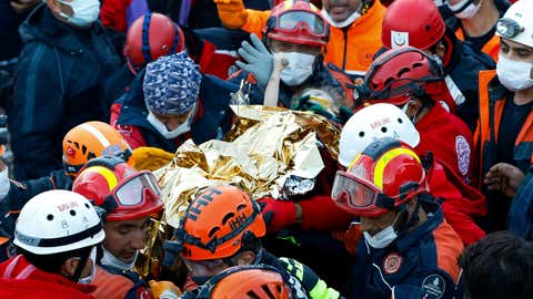 In this handout photo made available by the Istanbul Fire Authority, members of various rescue services carry 3-year-old Elif Perincek, after she was rescued from the rubble of a building some 65 hours after a magnitude 6.6 earthquake in Izmir, Turkey, Monday, Nov. 2, 2020. Rescue teams continue ploughing through concrete blocs and debris of collapsed buildings in Turkey's third largest city in search of survivors of a powerful earthquake that struck Turkey's Aegean coast and north of the Greek island of Samos, Friday Oct. 30, killing dozens. Close to a thousand people were injured. (Istanbul Fire Authority via AP)