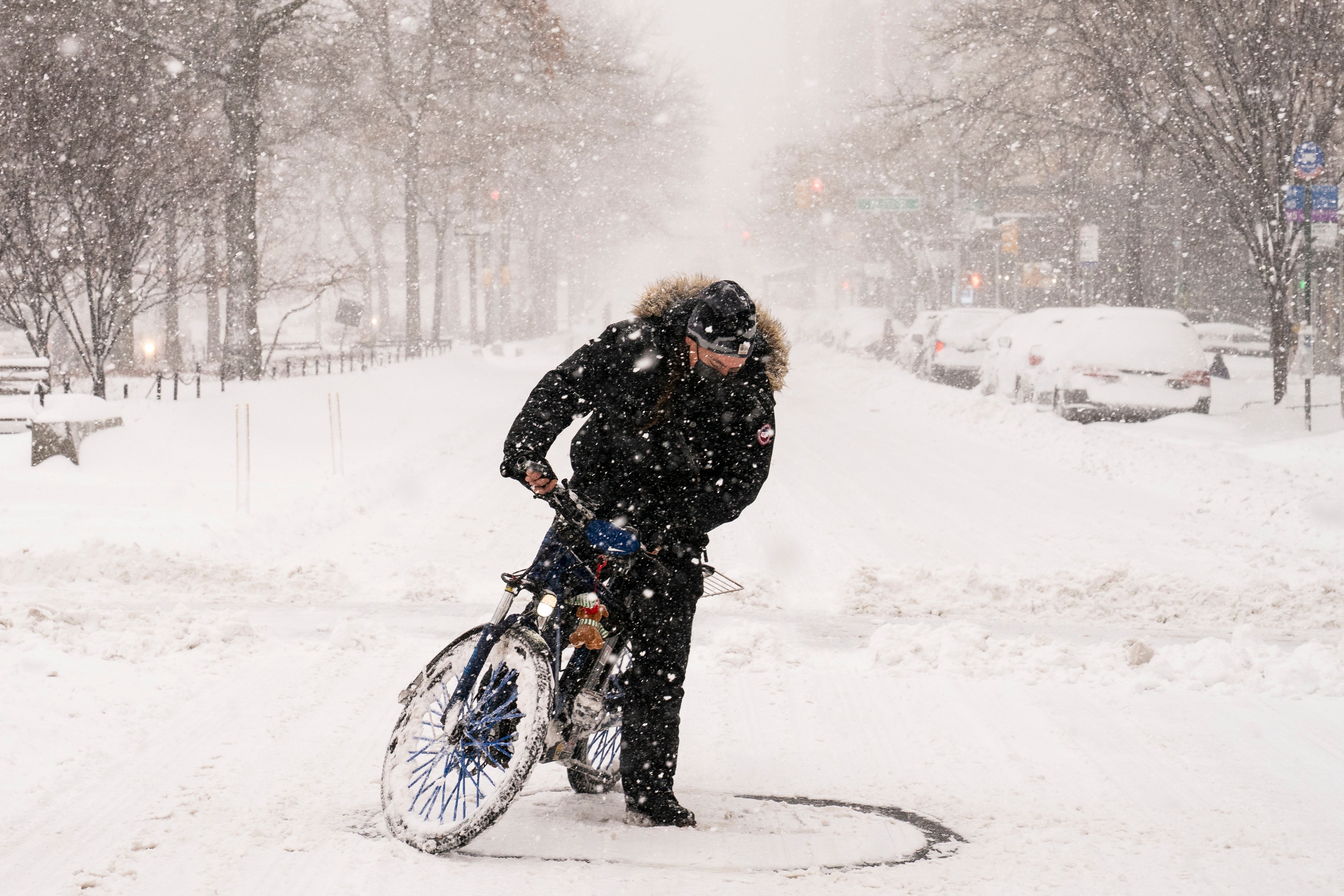 A cyclist on an electric bicycle does donuts on Broadway during a snowstorm, Monday, Feb. 1, 2021, in the Manhattan borough of New York. (AP Photo/John Minchillo)