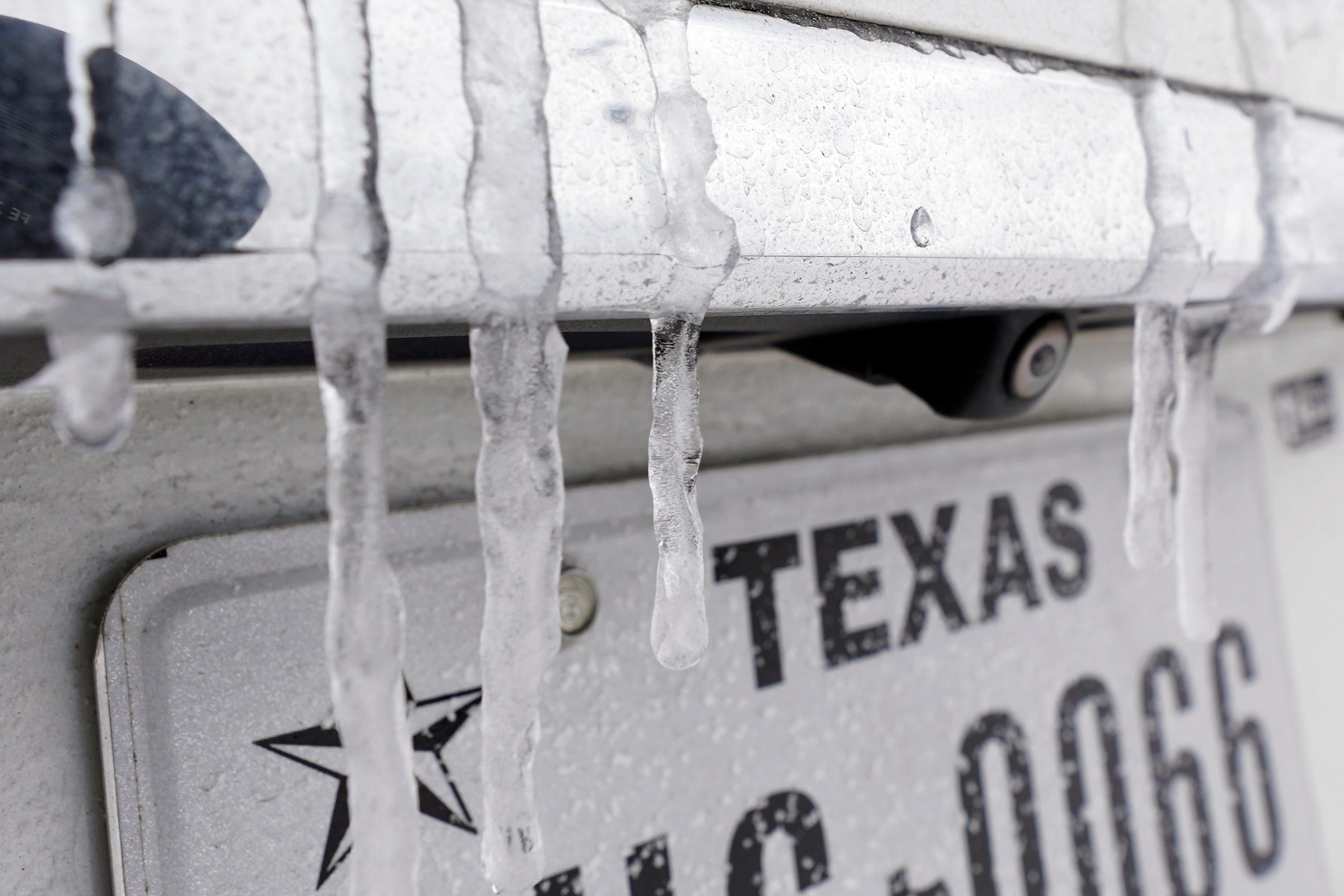 Icicles hang on the back of a vehicle Monday, Feb. 15, 2021, in Houston. A frigid blast of winter weather across the U.S. plunged Texas into an unusually icy emergency Monday that knocked out power to more than 2 million people and shut down grocery stores and dangerously snowy roads. (AP Photo/David J. Phillip)