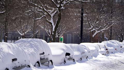 Car parked for several days Tuesday, Feb. 16, 2021, are covered in cumulative snow in Chicago, the morning after a snowstorm dumped up to 18 inches in the greater Chicago area. (AP Photo/Charles Rex Arbogast)