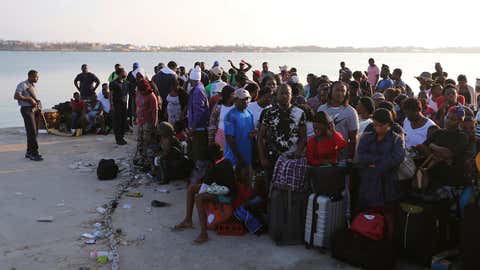 A line of people waits for evacuation to Nassau at the Port in Marsh Harbour on Abaco Island, on Saturday, September 7, 2019. (AP Photo/Fernando Llano)