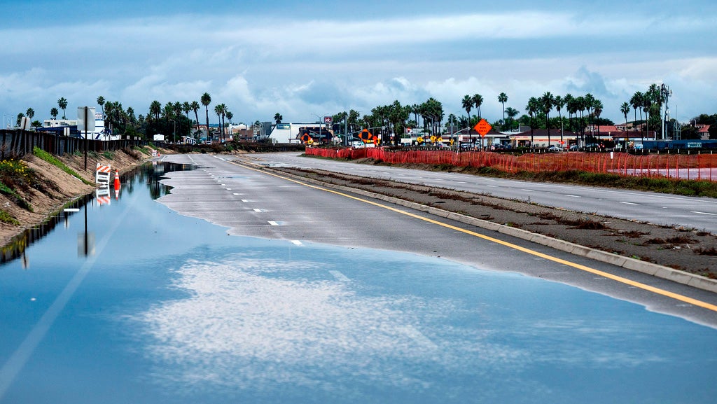 Water covers a stretch of Highway 1, which remained closed in both directions due to flooding, on Saturday, Nov. 15, 2025, in Huntington Beach, Calif. (AP Photo/Noah Berger)