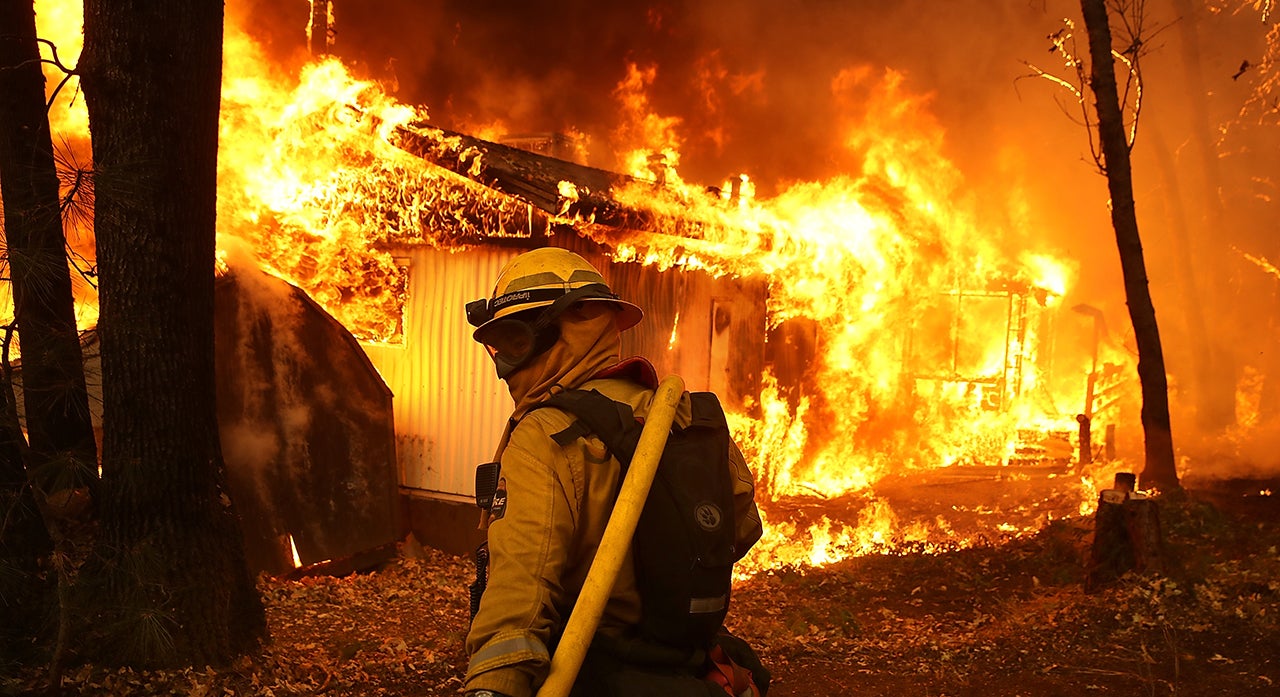 A Cal Fire firefighter monitors a burning home as the Camp Fire moves through the area on November 9, 2018, in Magalia, California. Fueled by high winds and low humidity, the rapidly spreading Camp Fire ripped through the town of Paradise and killed 85 people. (Justin Sullivan/Getty Images)