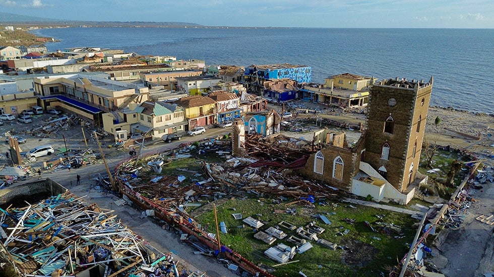 BLACK RIVER, ST. ELIZABETH, JAMAICA: An aerial view of damaged buildings around the St. John's Anglican Church following the passage of Hurricane Melissa in Black River on Wednesday, October 29, 2025. (Photo by RICARDO MAKYN/AFP via Getty Images)