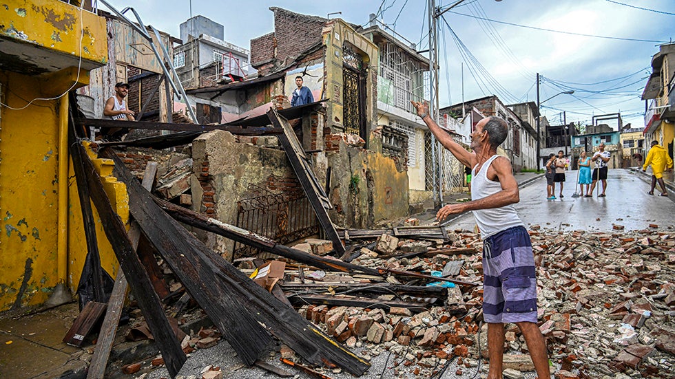 SANTIAGO DE CUBA, CUBA: Residents inspect a house destroyed by Hurricane Melissa in a neighborhood of Santiago de Cuba on Wednesday, October 29, 2025. (Photo by YAMIL LAGE/AFP via Getty Images)