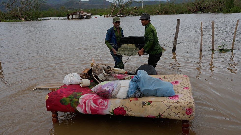 SANTIAGO DE CUBA, CUBA: People recover belongings from a home flooded by Hurricane Melissa on Wednesday, Oct. 29, 2025. (AP Photo/Ram&oacute;n Espinosa)