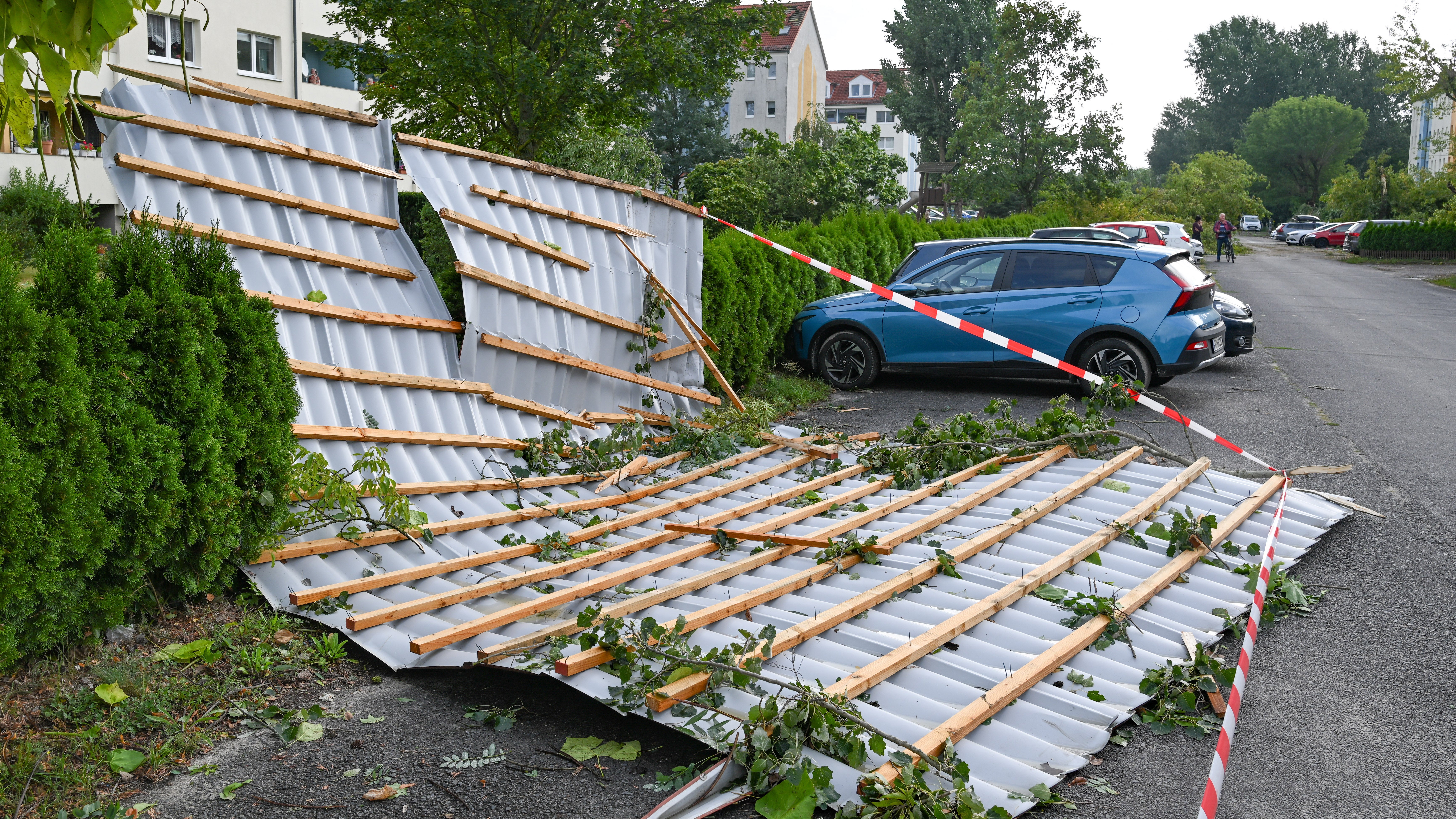 20.08.2026, Brandenburg, F&uuml;rstenwalde/Spree: Ein Blechdach eines Kindergartens liegt nach einem Tornado auf der Stra&szlig;e. Der Deutsche Wetterdienst best&auml;tigt, dass es im brandenburgischen F&uuml;rstenwalde/Spree einen Tornado gegeben hat. (Patrick Pleul/dpa)