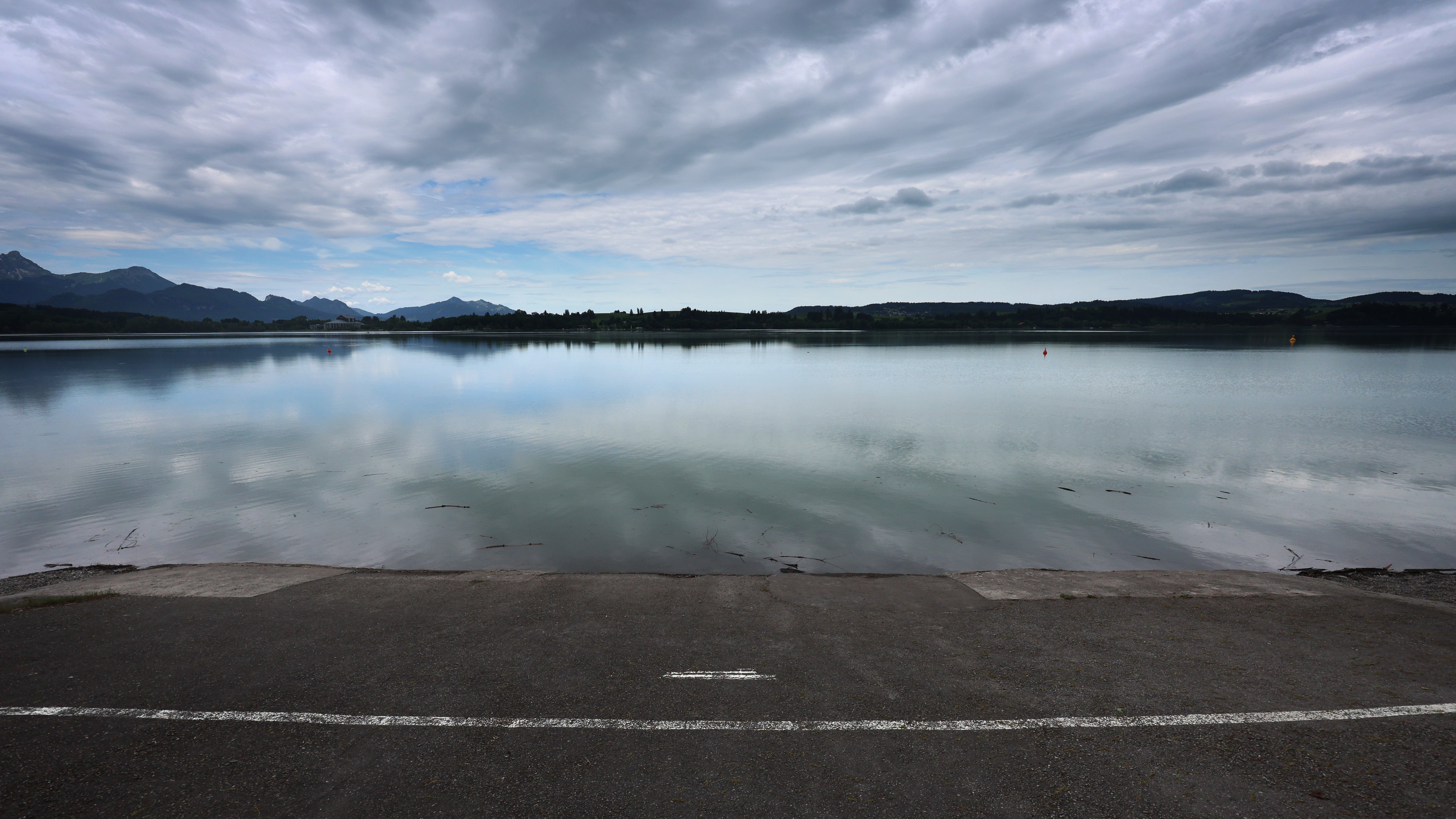 01.06.2025, Bayern, F&uuml;ssen: Eine Anlegestelle der Forggensee-Schifffahrt am Ufer des am Alpenrand gelegenen Forggensees. Wegen des niedrigen Wasserstandes musste der Saisonstart der Forggensee-Schifffahrt verschoben werden.  (Karl-Josef Hildenbrand/dpa)