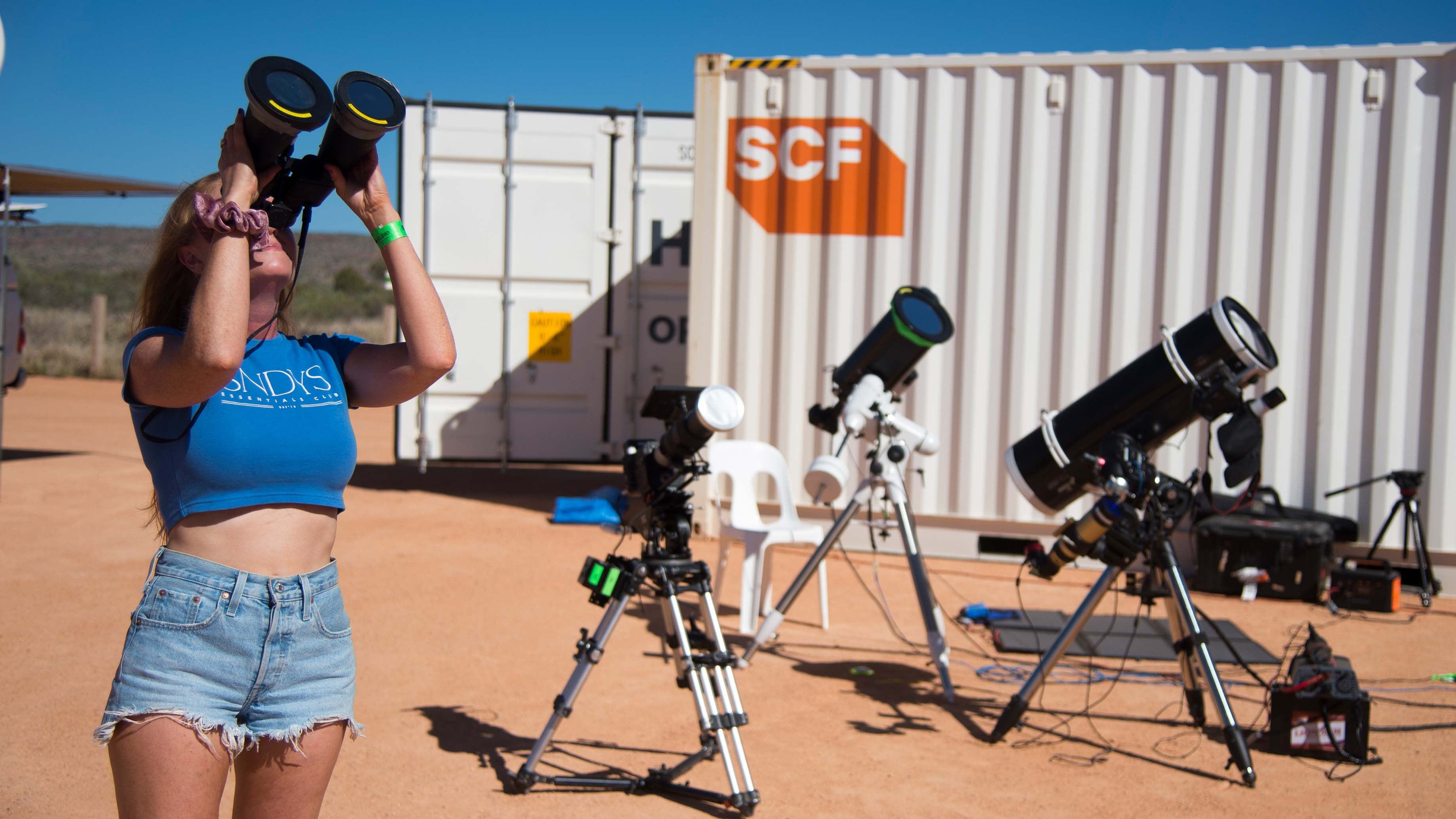 People gather ahead of a total solar eclipse at a viewing site 24km from Exmouth, Western Australia, Thursday, April 20, 2023. (AAP Image/Aaron Bunch) NO ARCHIVING