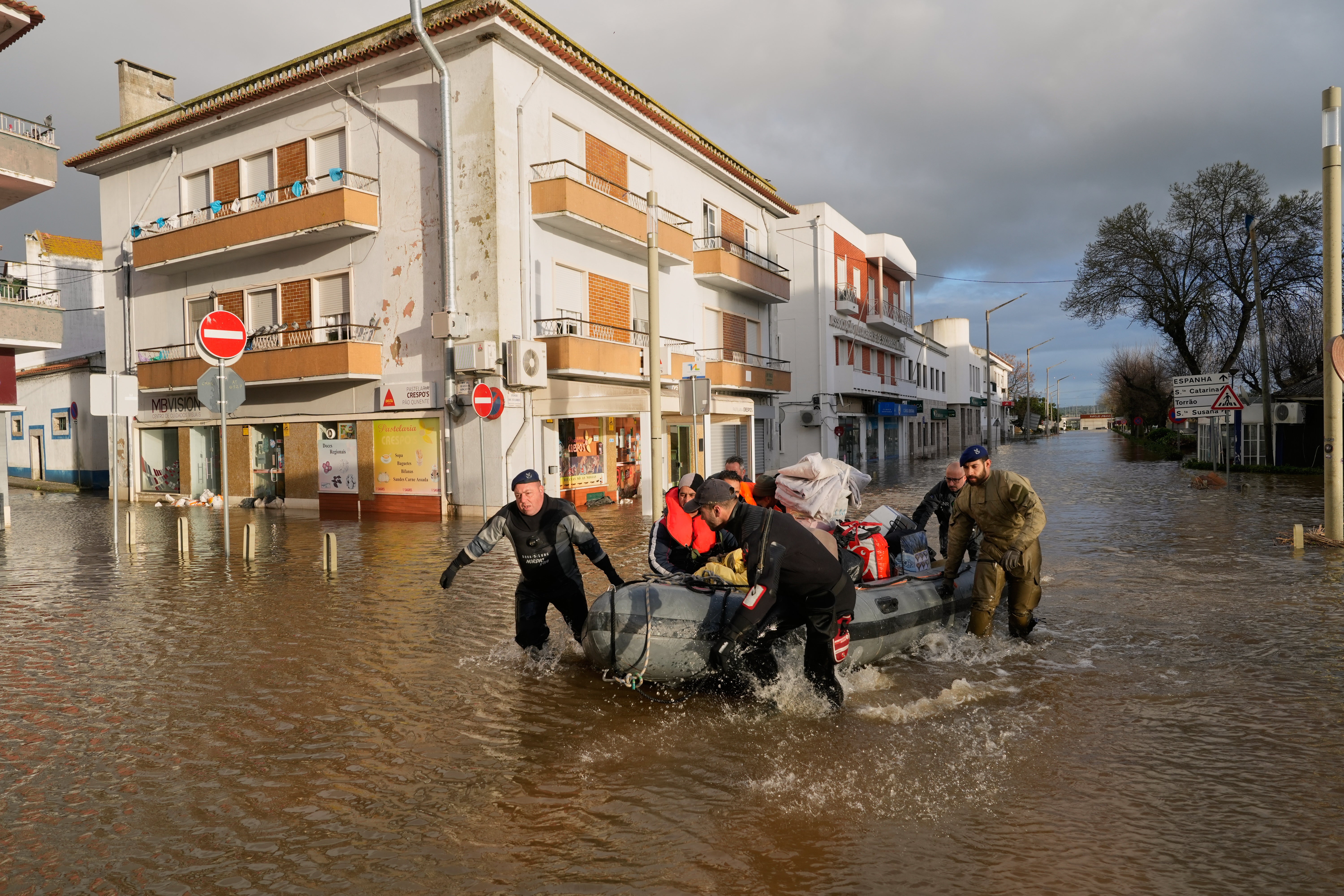 06.02.2026, Portugal, Alcacer do Sal: Polizisten und Marinesoldaten evakuieren Bewohner eines Hotels mit Schlauchbooten aus einer &uuml;berschwemmten Stra&szlig;e, nachdem der Fluss Sado nach heftigen Regenf&auml;llen in Alcacer do Sal in S&uuml;dportugal &uuml;ber die Ufer getreten ist. (Ana Brigida/AP/dpa)