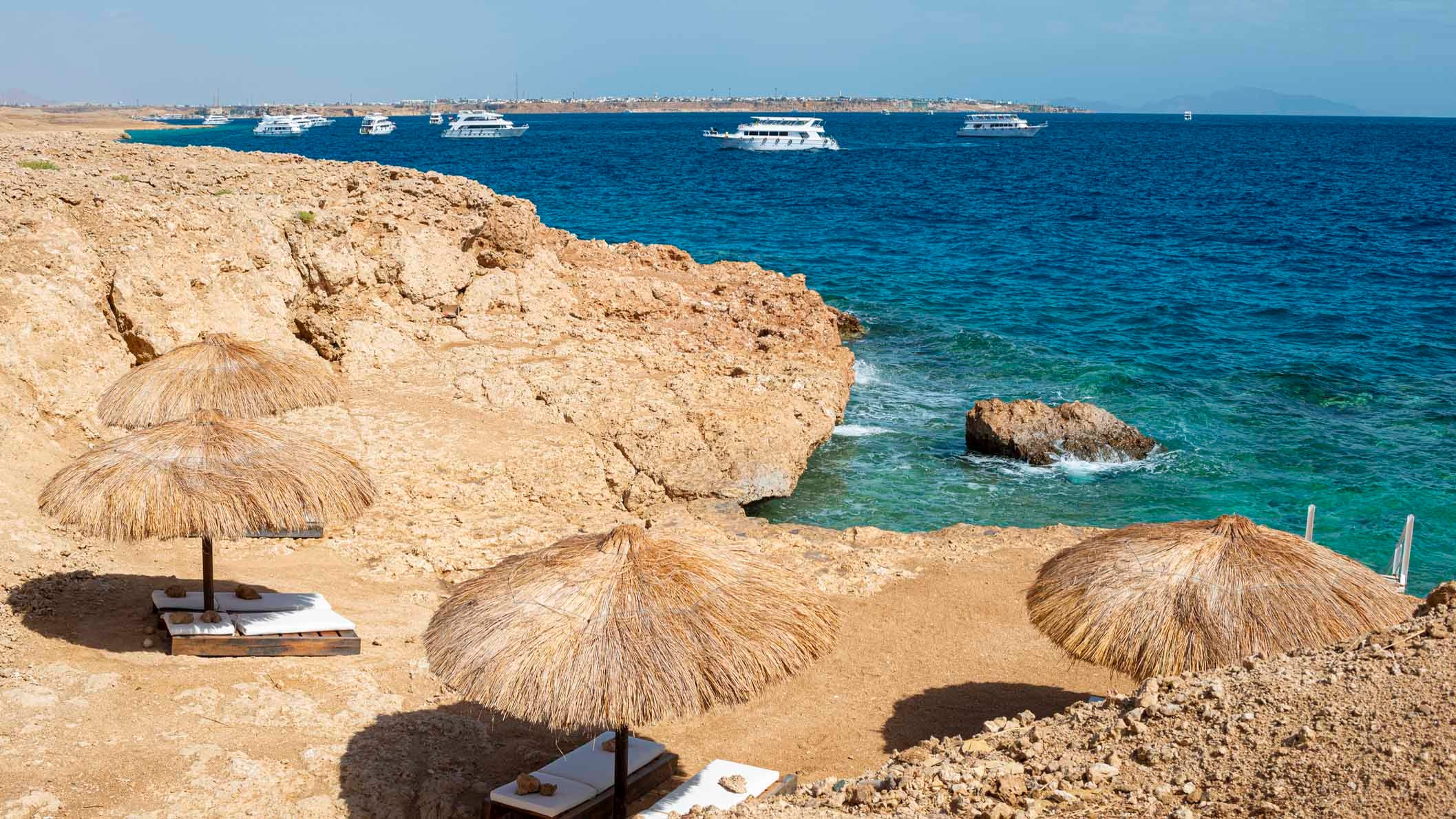 Sun bed and umbrella straw outside the village on Sharm el Sheikh. Sinai,Egypt