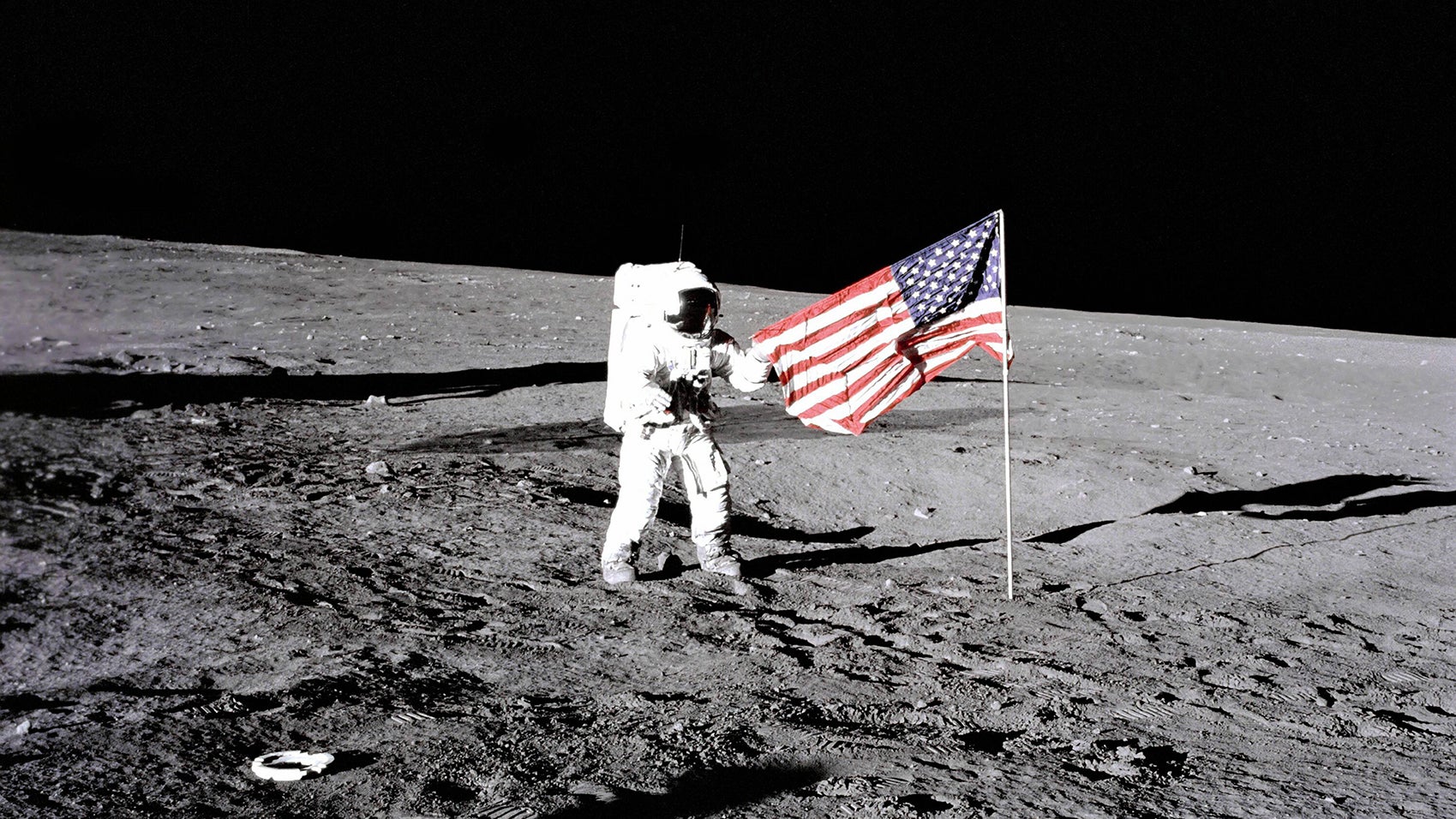 Apollo 12 astronaut stands beside the United States flag after it was unfurled on the lunar surface during the first extravehicular activity. Several footprints made by the crew can be seen in the photograph. PUBLICATIONxINxGERxSUIxAUTxONLY Copyright: StocktrekxImages stk200060sApollo 12 Astronaut stands Beside The United States Flag After IT what unfurled ON The Lunar Surface during The First extravehicular Activity several Footprints Made by The Crew CAN Be Lakes in The Photo PUBLICATIONxINxGERxSUIxAUTxONLY Copyright StocktrekxImages stk200060s