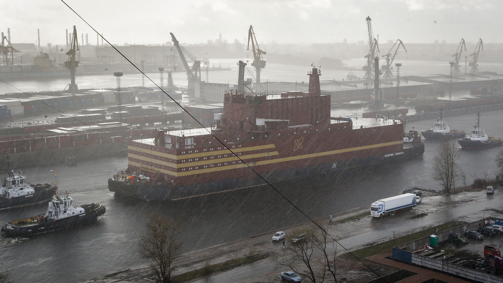 FILE - In this Saturday, April 28, 2018 file photo, the floating nuclear power plant, the 'Akademik Lomonosov', is towed out of the St. Petersburg shipyard where it was constructed in St. Petersburg, Russia. The Akademik Lomonosov that carries two 35-megawatt nuclear reactors set out Friday Aug. 23, 2019, from the Arctic port of Murmansk on the Kola Peninsula on a three-week journey to Pevek on the Chukotka Peninsula. (AP Photo/Dmitri Lovetsky, File) 