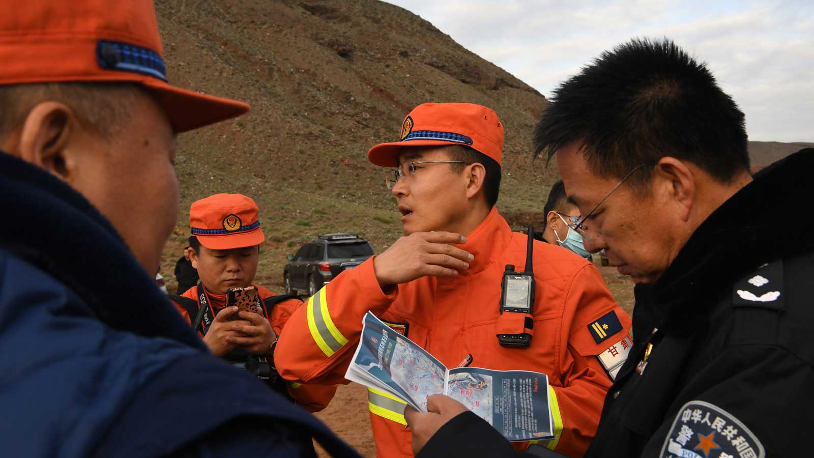 23.05.2021, China, Jingtai: Rettungskr&auml;fte besprechen die Details der Suche nach &Uuml;berlebenden. Mindestens 21 Teilnehmer eines Bergmarathons im Nordwesten Chinas sind bei extremem Unwetter ums Leben gekommen. Acht weitere Teilnehmer des Ultramarathons in der Touristenattraktion des Steinwalds am Gelben Fluss in Baiyin wurden zur Behandlung in Krankenh&auml;user gebracht, wie chinesische Staatsmedien am Sonntag berichteten. Foto: Fan Peishen/XinHua/dpa +++ dpa-Bildfunk +++