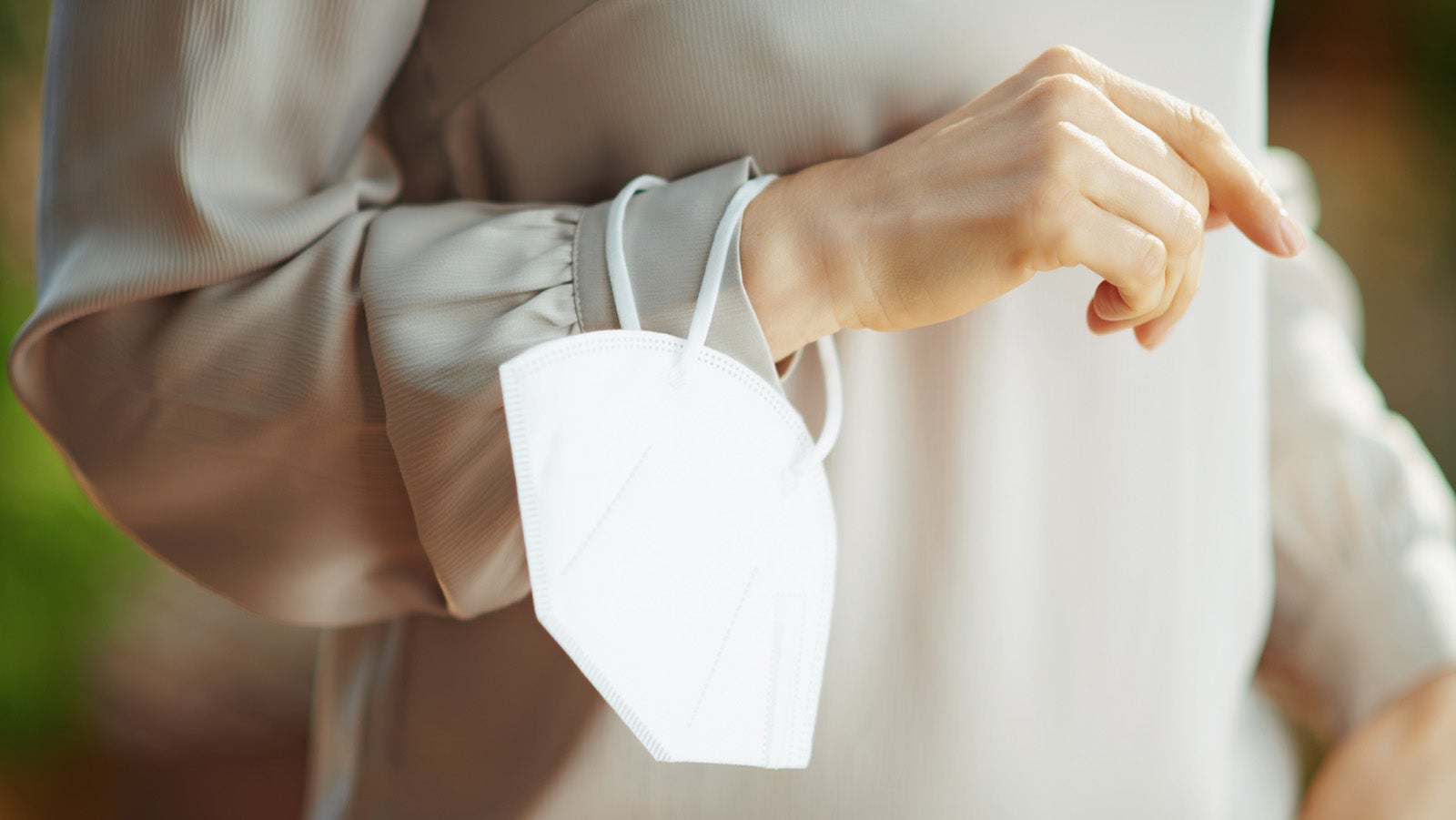 coronavirus pandemic. Closeup on female in grey blouse with ffp2 mask.