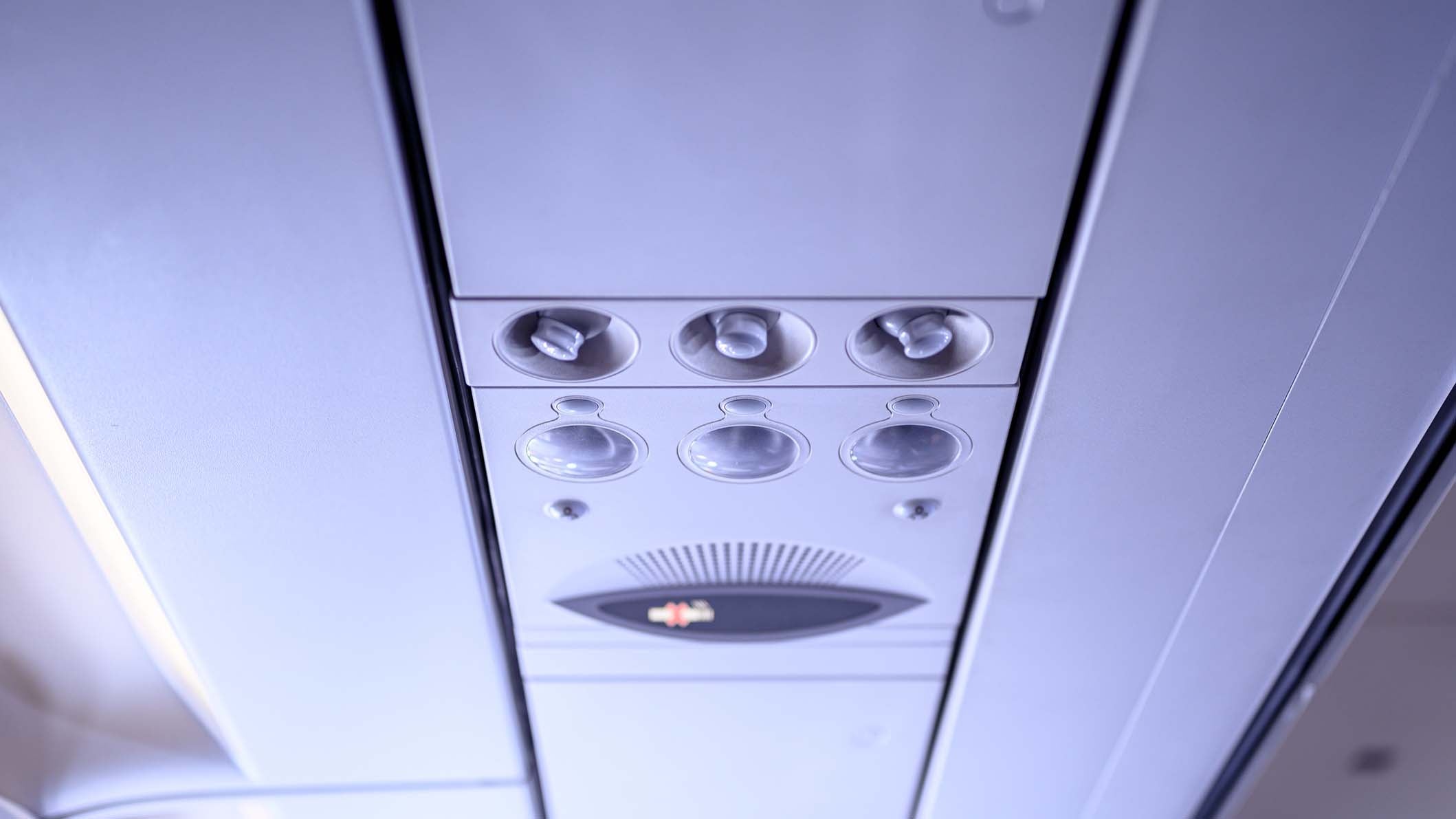 Overheaded electronic fans, light, air-condition, cabin details inside airplane.