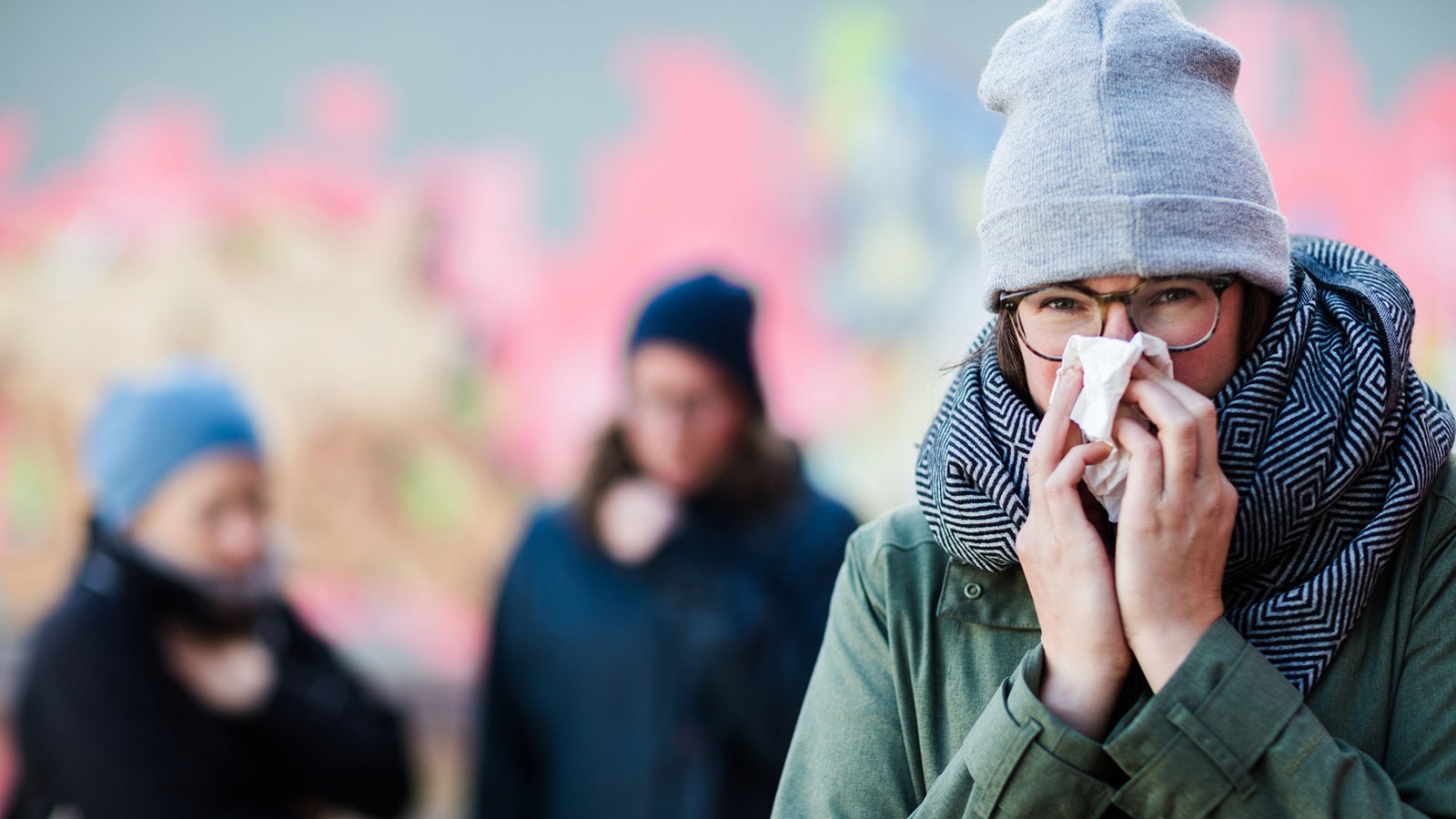 Three female friends or students having a cold and coughing