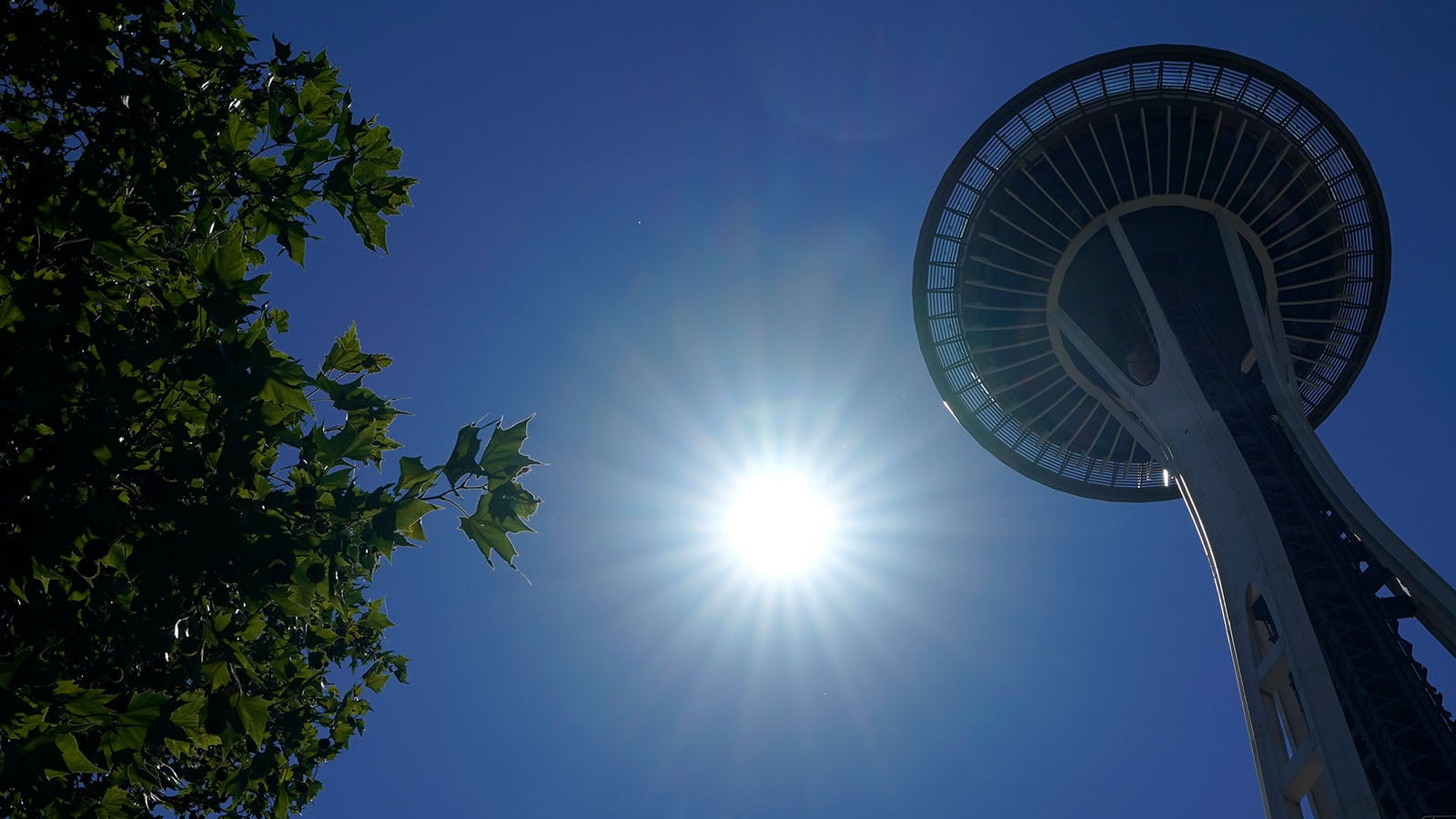 The sun shines near the Space Needle, Monday, June 28, 2021, in Seattle. Seattle and other cities broke all-time heat records over the weekend, with temperatures soaring well above 100 degrees Fahrenheit (37.8 Celsius). (AP Photo/Ted S. Warren)