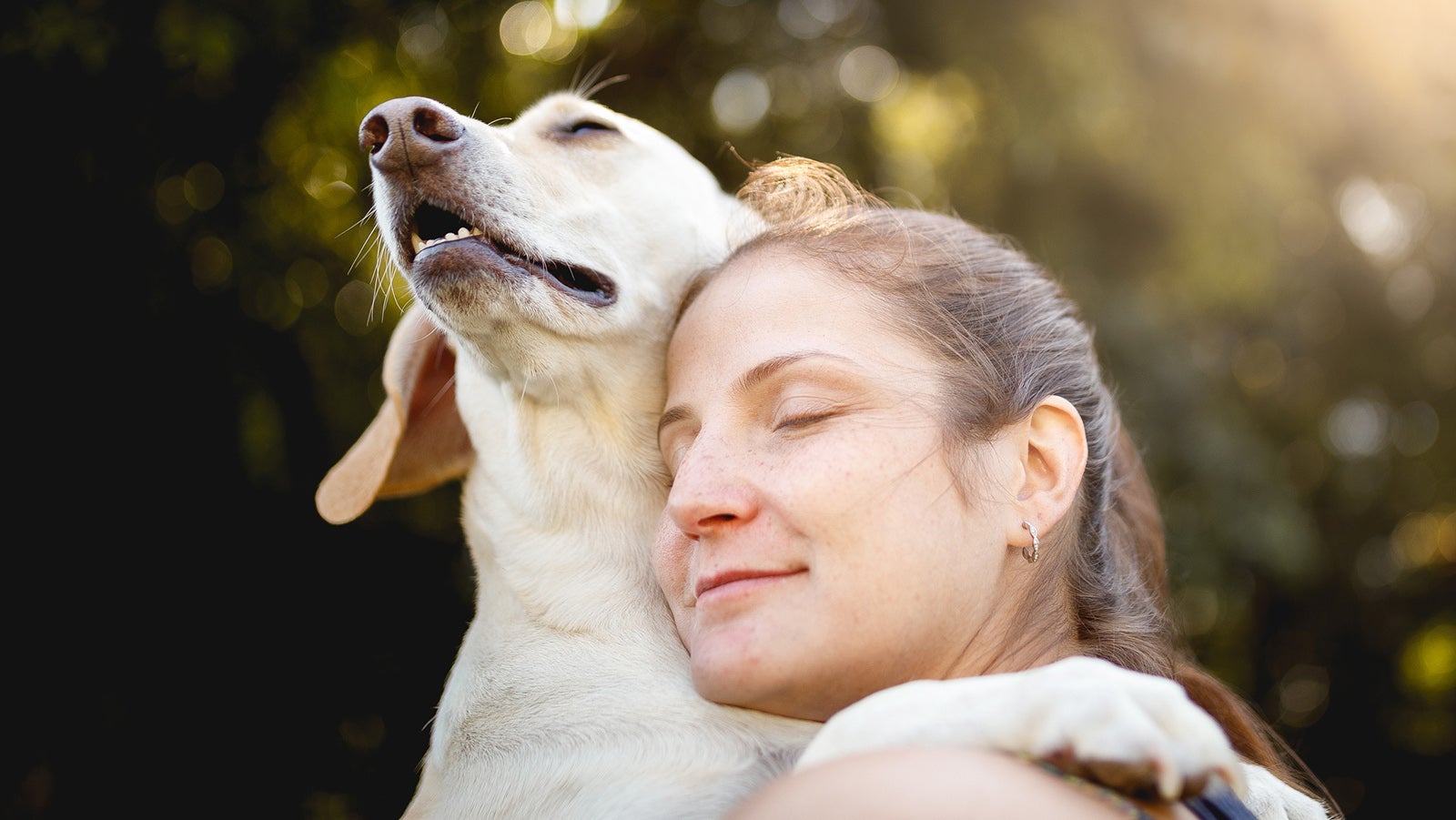 Woman hugging her dog.