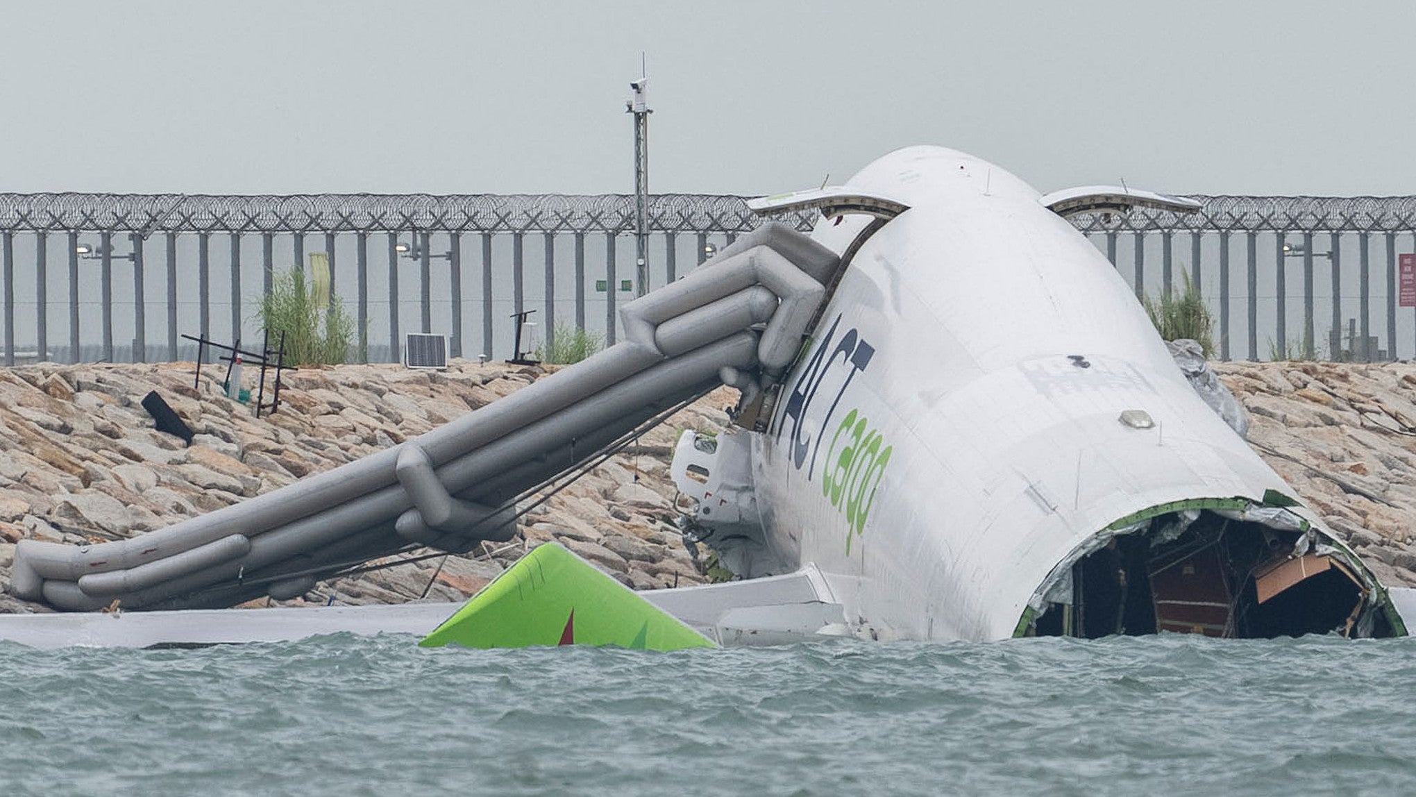 20.10.2025, Hongkong: Blick auf das Frachtflugzeug, das auf dem Flughafen in Hongkong von der Landebahn abgekommen ist und &uuml;ber die Piste hinaus ins Meer schlitterte. Auf dem Flughafen der Millionenmetropole Hongkong ist es zu einem t&ouml;dlichen Flugzeugungl&uuml;ck gekommen. (Chan Long Hei/AP/dpa)

