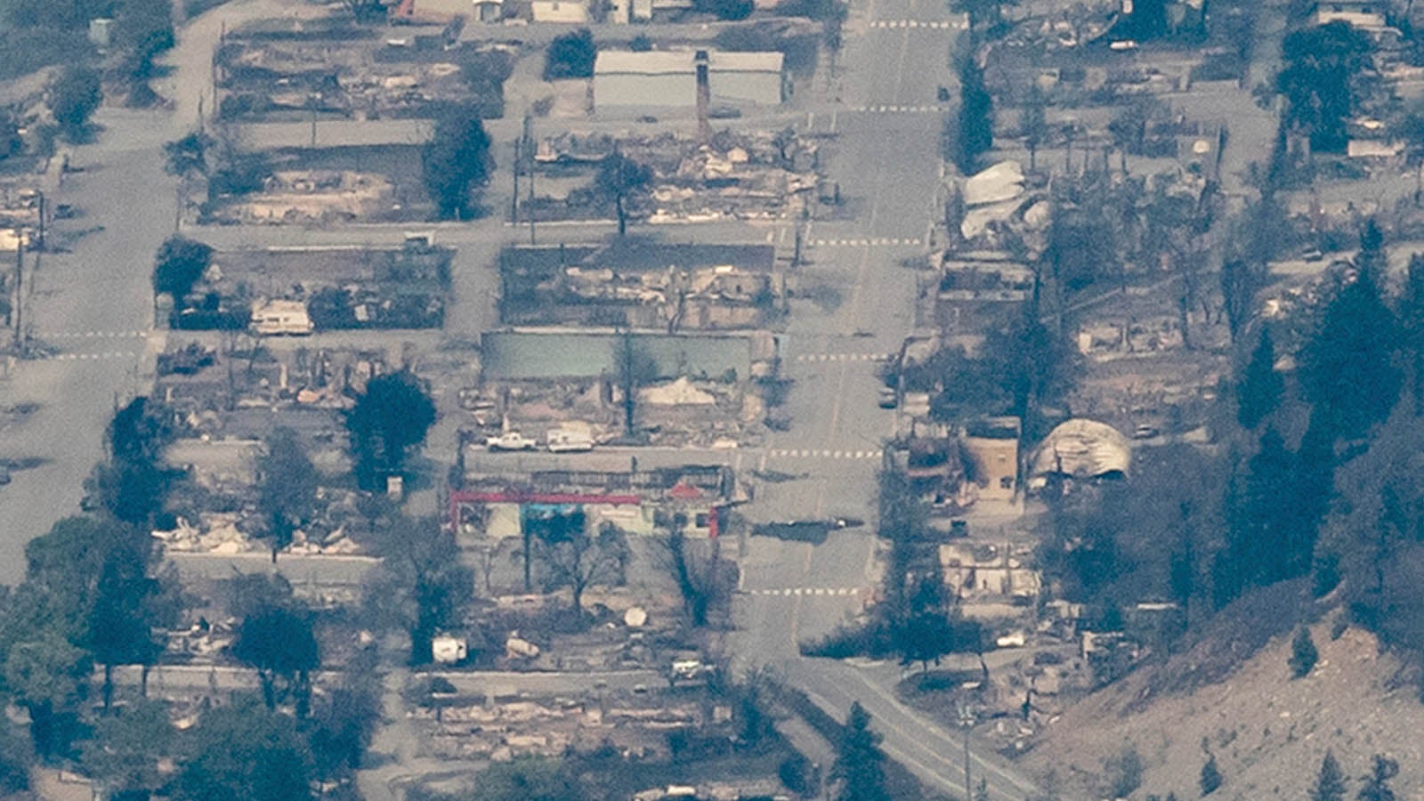 In this aerial photo taken from a helicopter, structures destroyed by wildfire are seen in Lytton, British Columbia, on Thursday, July 1, 2021. Lytton city council member Lilliane Graie, on behalf of Mayor Jan Polderman, said in an email Thursday that the fire had devastated the town, a village about 153 kilometers (95 miles) northeast of Vancouver. (Darryl Dyck/The Canadian Press via AP)