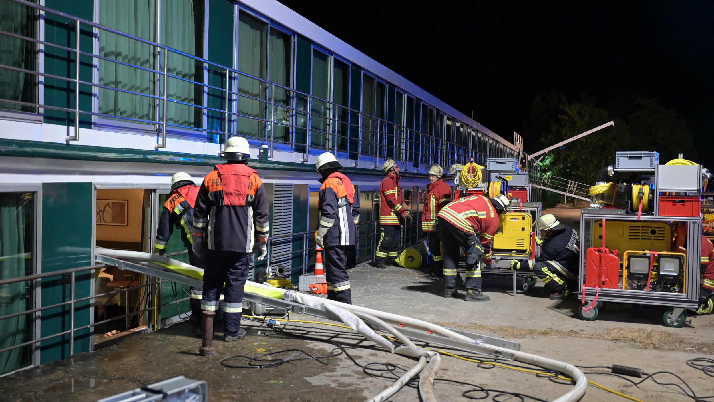 HANDOUT - 03.06.2023, Bayern, Karlstadt: Die Feuerwehr arbeitet an einem Passagierschiff auf dem Main. Passagiere und Crewmitglieder wurden nach einem Schiffsunfall evakuiert. Am Samstagabend schlug das Schiff auf dem Main bei Karlstadt (Landkreis Main-Spessart) leck, wie die Polizei am Sonntag mitteilte. Nach ersten Erkenntnissen der Polizei wurde es durch einen Fahrfehler des Schiffsf&uuml;hrers durch einen kleinen Felsen am Grund des Mains besch&auml;digt. Das Passagierschiff war nach Angaben der Polizei von Budapest nach D&uuml;sseldorf unterwegs. Foto: Benedict Rottmann/Kreisbrandinspektion Main-Spessart/dpa - ACHTUNG: Nur zur redaktionellen Verwendung im Zusammenhang mit der aktuellen Berichterstattung und nur mit vollst&auml;ndiger Nennung des vorstehenden Credits +++ dpa-Bildfunk +++