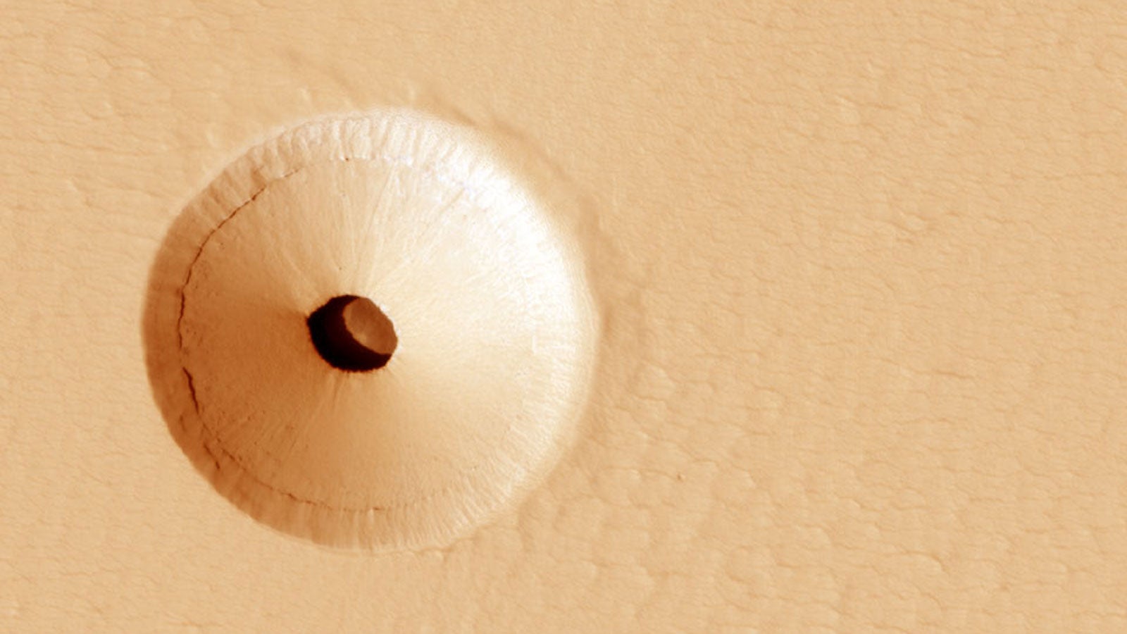 NASA, JPL, U. Arizona; The hole was discovered by chance in 2011 on images of the dusty slopes of Mars' Pavonis Mons volcano taken by the HiRISE instrument aboard the robotic Mars Reconnaissance Orbiter currently circling Mars
https://apod.nasa.gov/apod/ap200301.html