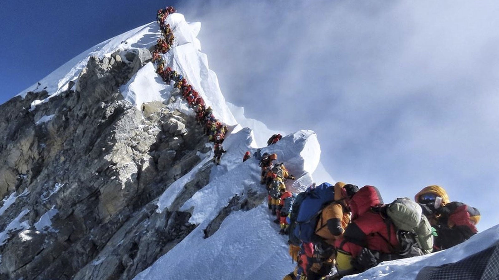 In this photo made on May 22, 2019, a long queue of mountain climbers line a path on Mount Everest. About half a dozen climbers died on Everest last week most while descending from the congested summit during only a few windows of good weather each May. 