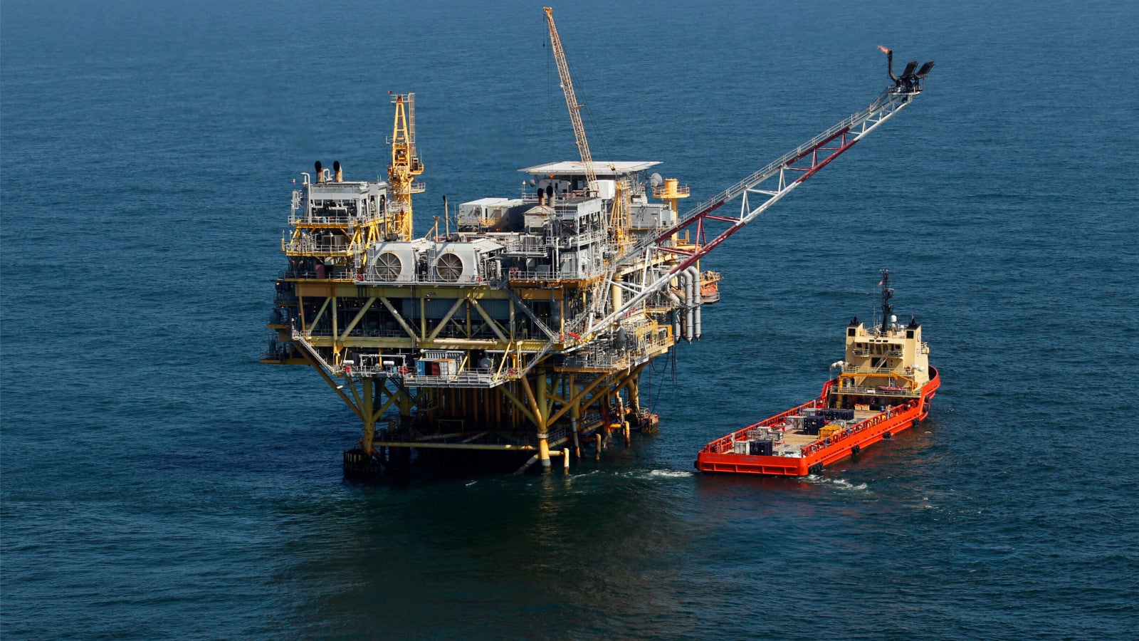 A supply vessel boat sits near an oil rig in the Gulf of Mexico, off the coast of Louisiana. April 10, 2011. AP Photo/Gerald Herbert, File