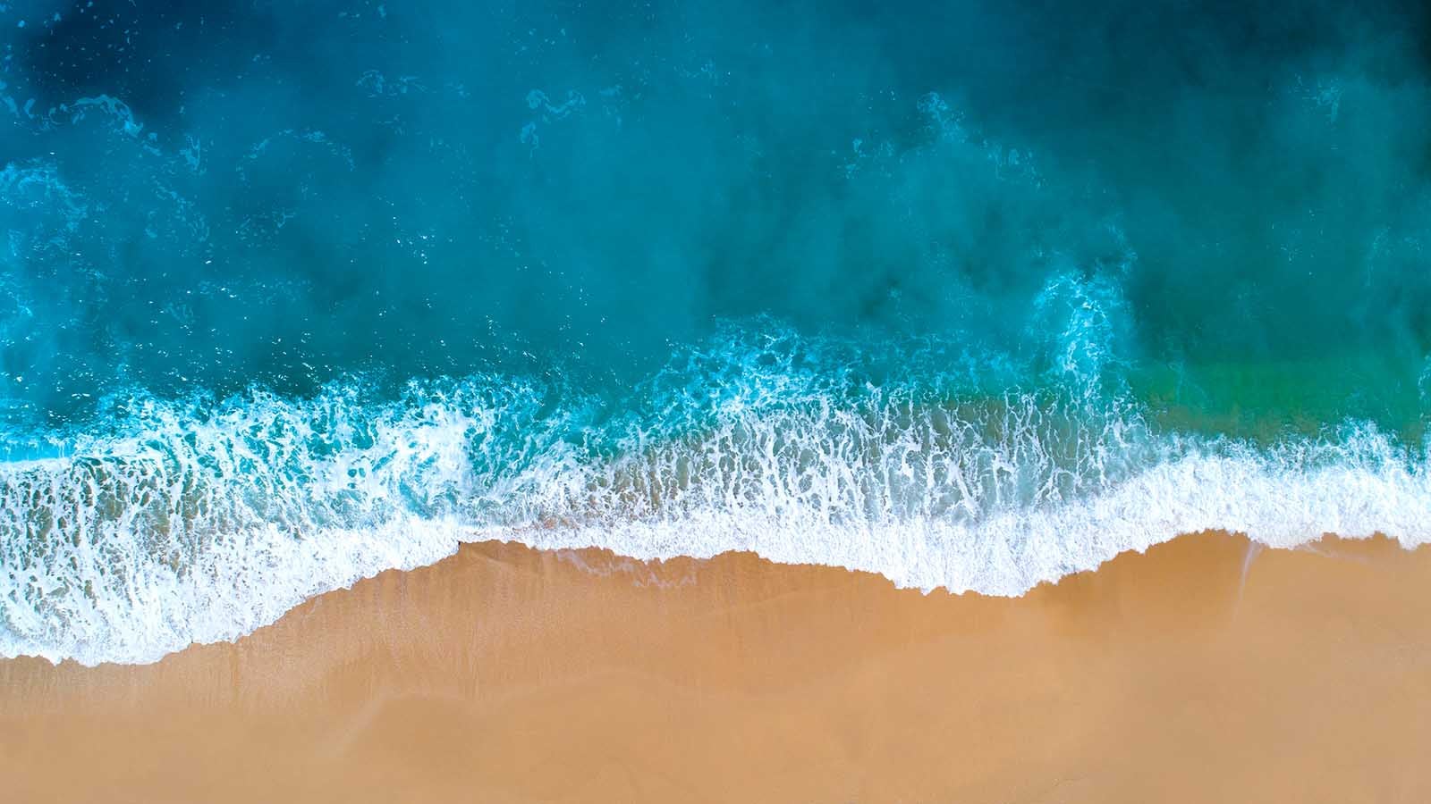 Aerial view of sandy beach, clear turquoise water. Mediterranean sea.